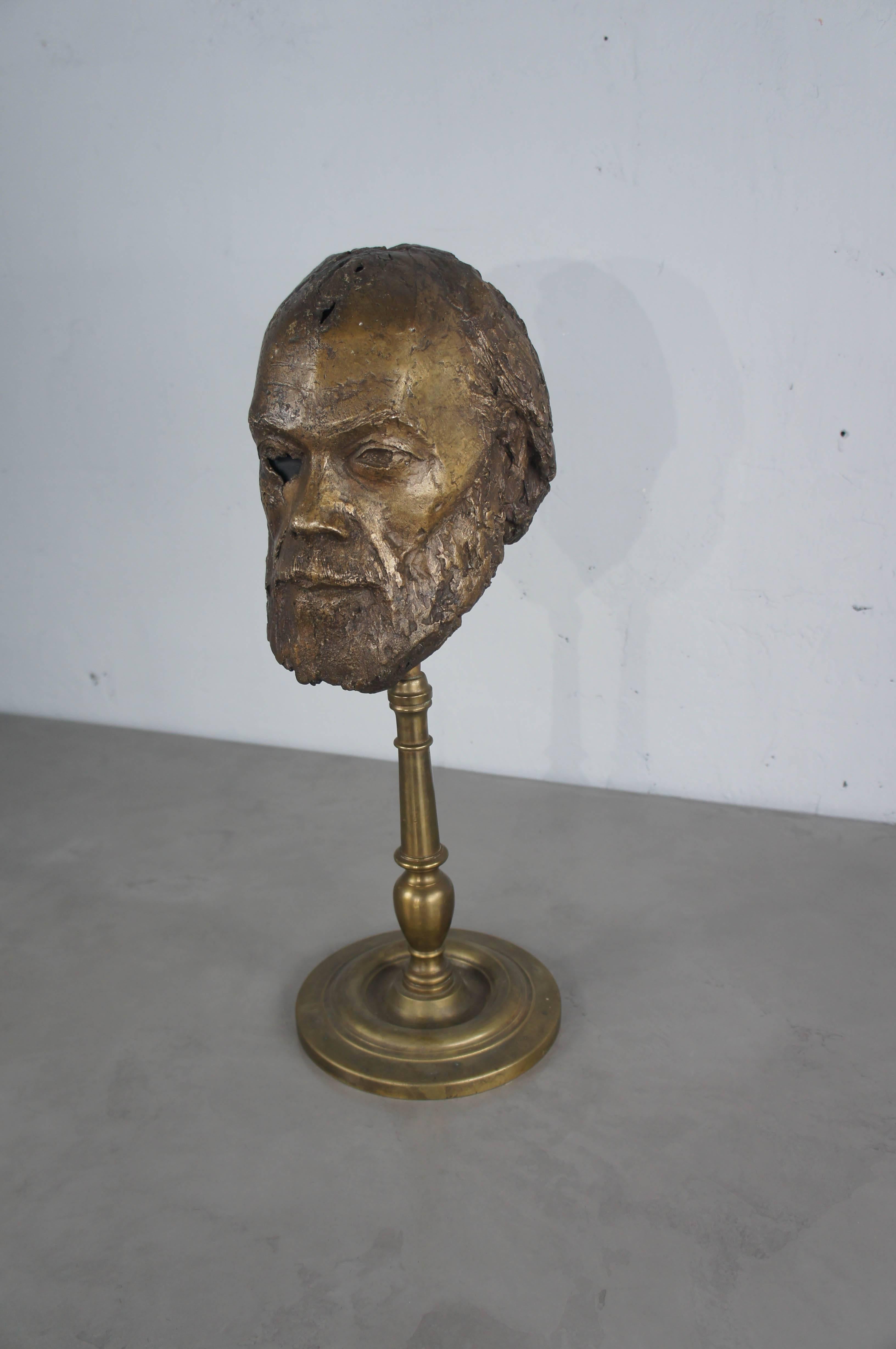 A stunning bronze head of a bearded man, half skeletal, signed in the maquette by French artist, Bernard Grollier. The head is in excellent condition and is mounted on a brass stand, which has a split as shown in picture, although this does not