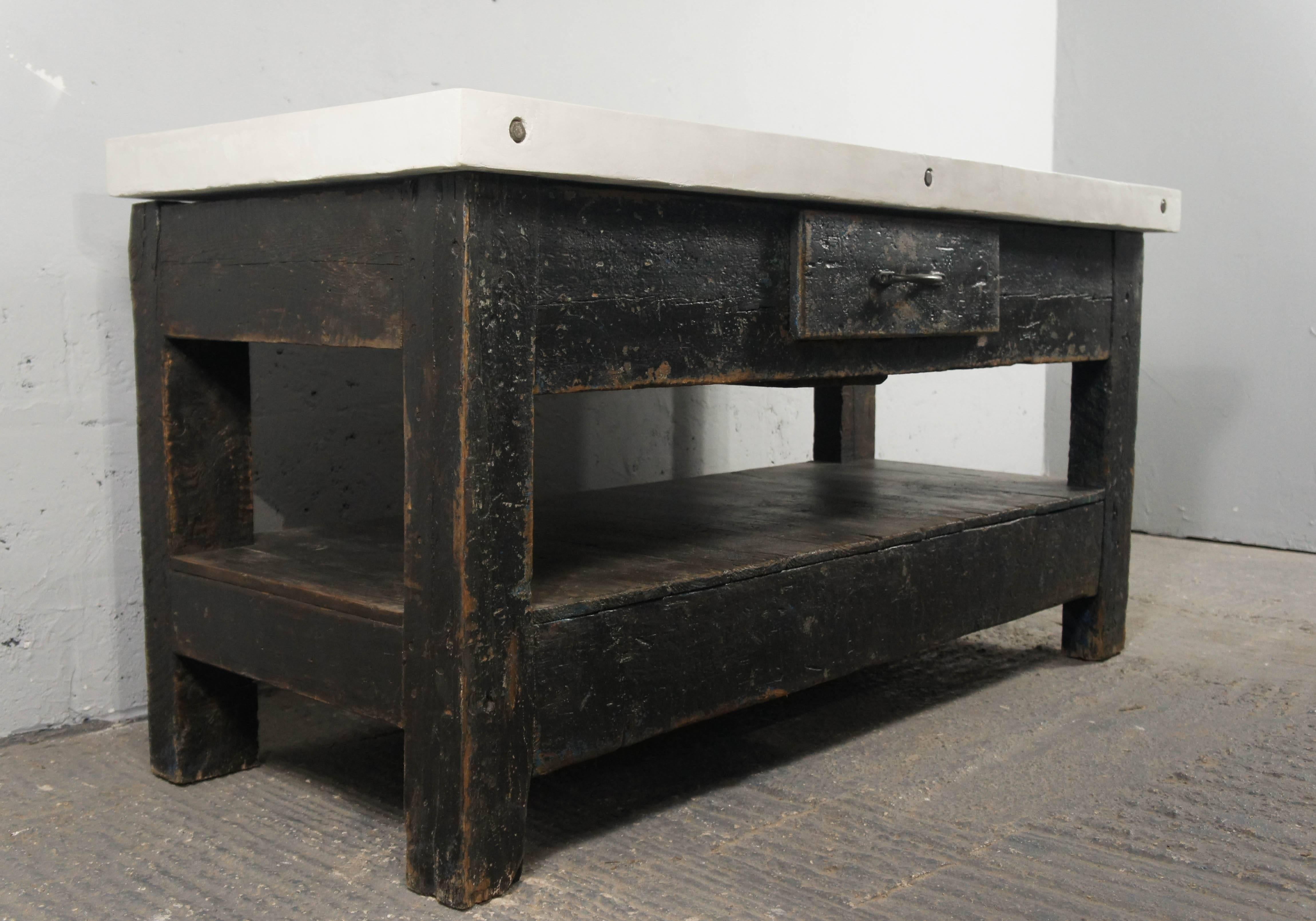 We salvaged a pair of these great workbenches from a steel factory in Sheffield, England; so they have lots of original character and history. 
We have teamed the bases up with modern cement resin tops, handmade by ourselves. The slightly off-white