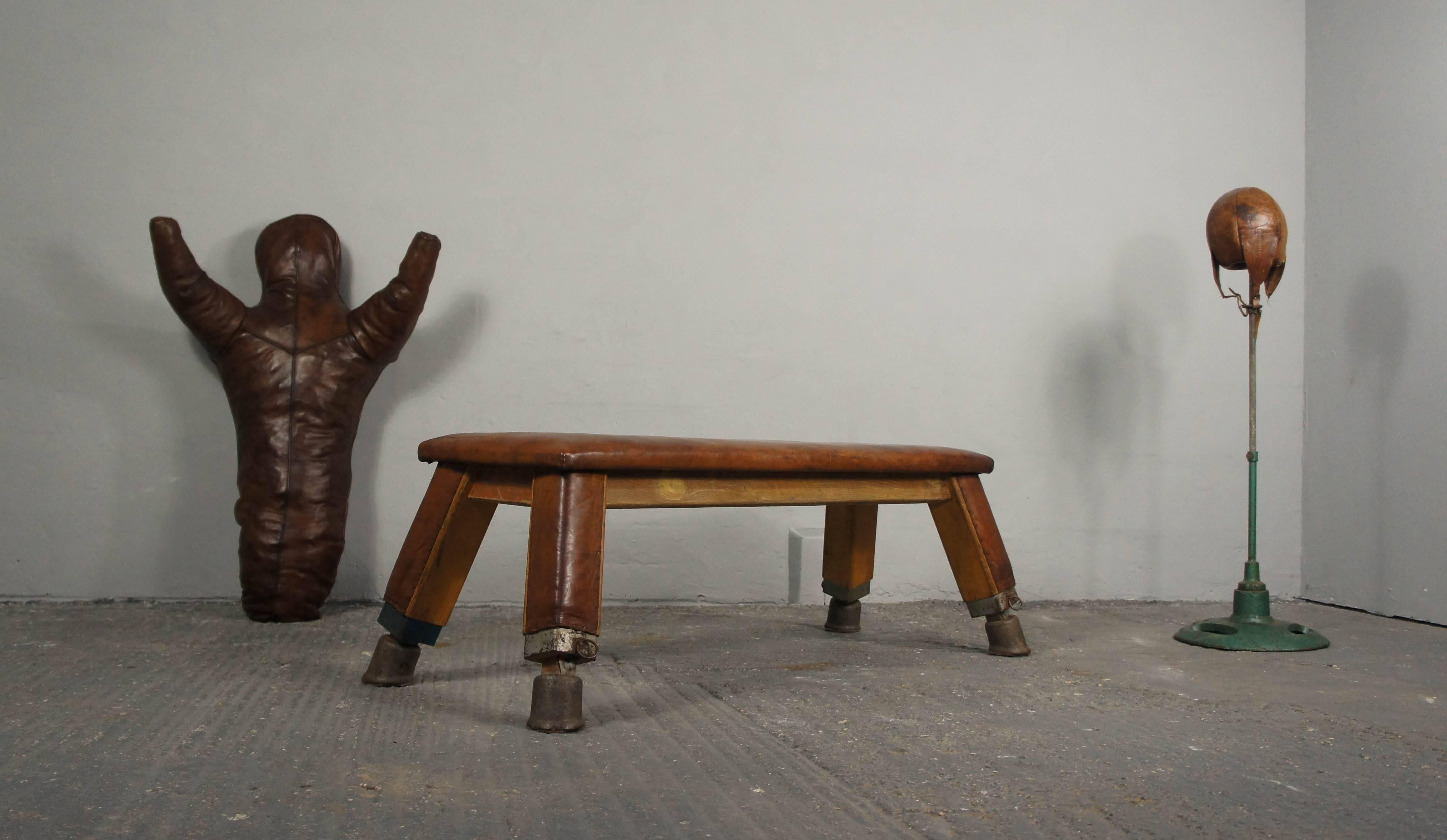 A rarer, smaller or child sized European wrestling dummy originating from the 1930s. It has beautifully worn and aged leather, intricate leather cross stitching on the rear side and stands just under 4'. Originally, they were used as training aids