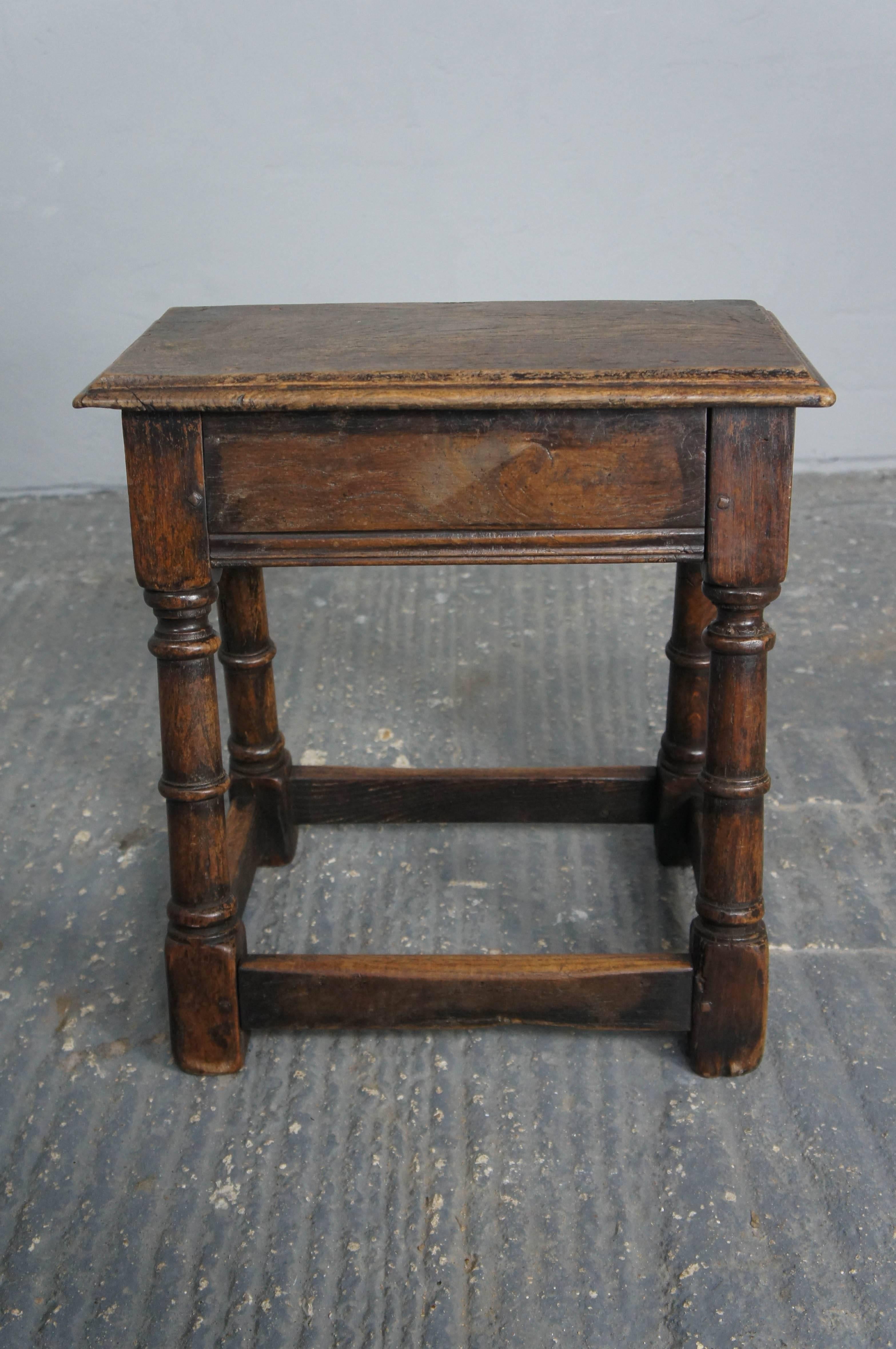 Excellent example of an English oak joint stool originating from the 1820s. Beautiful colour and patina, turned legs and pegged joints.