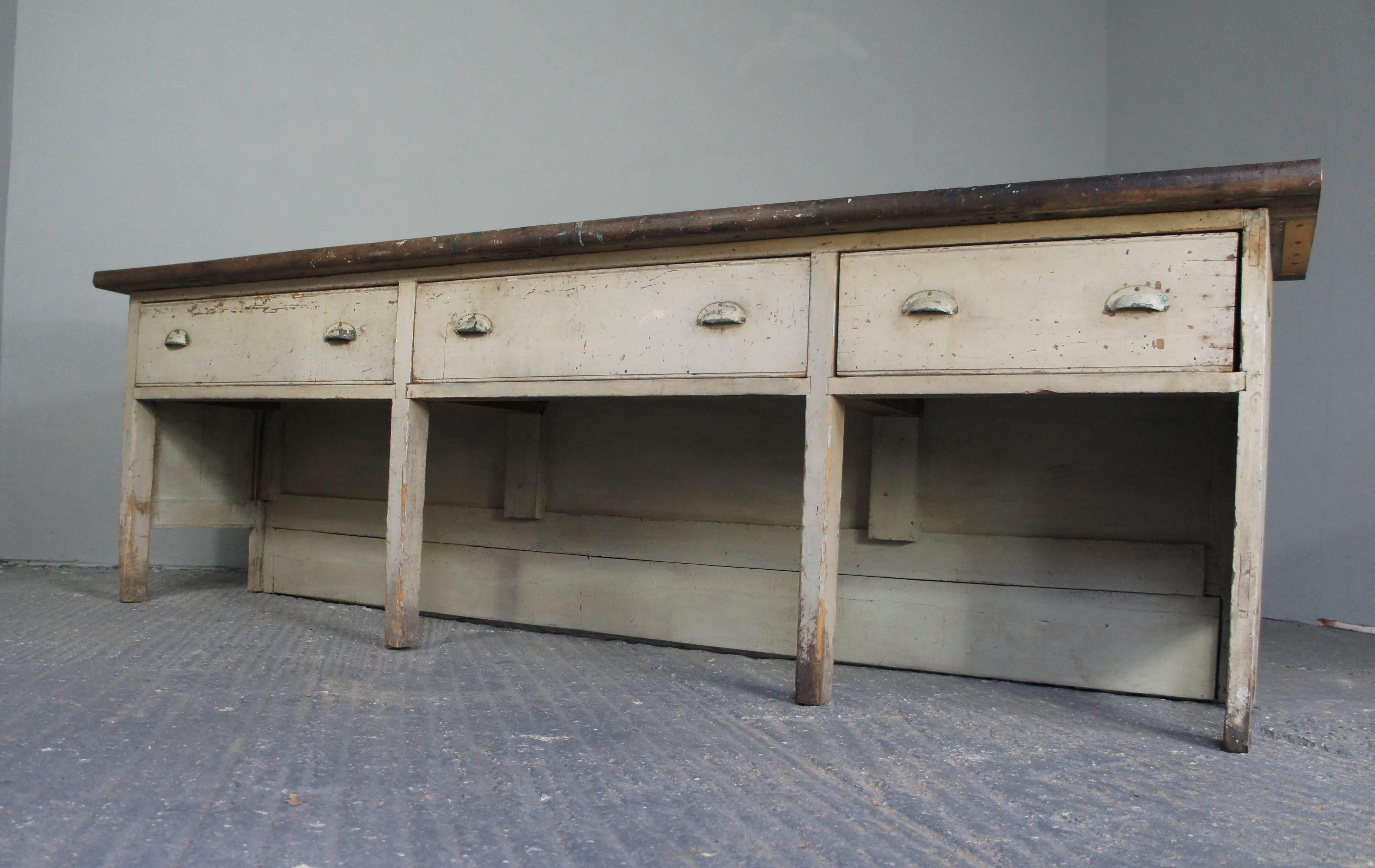 Victorian pine counter in mostly original paint, sourced from the north of England. At one time this was a much larger piece that has been cut down at some point. Original hardwood top that has some paint splashes which add history and character.