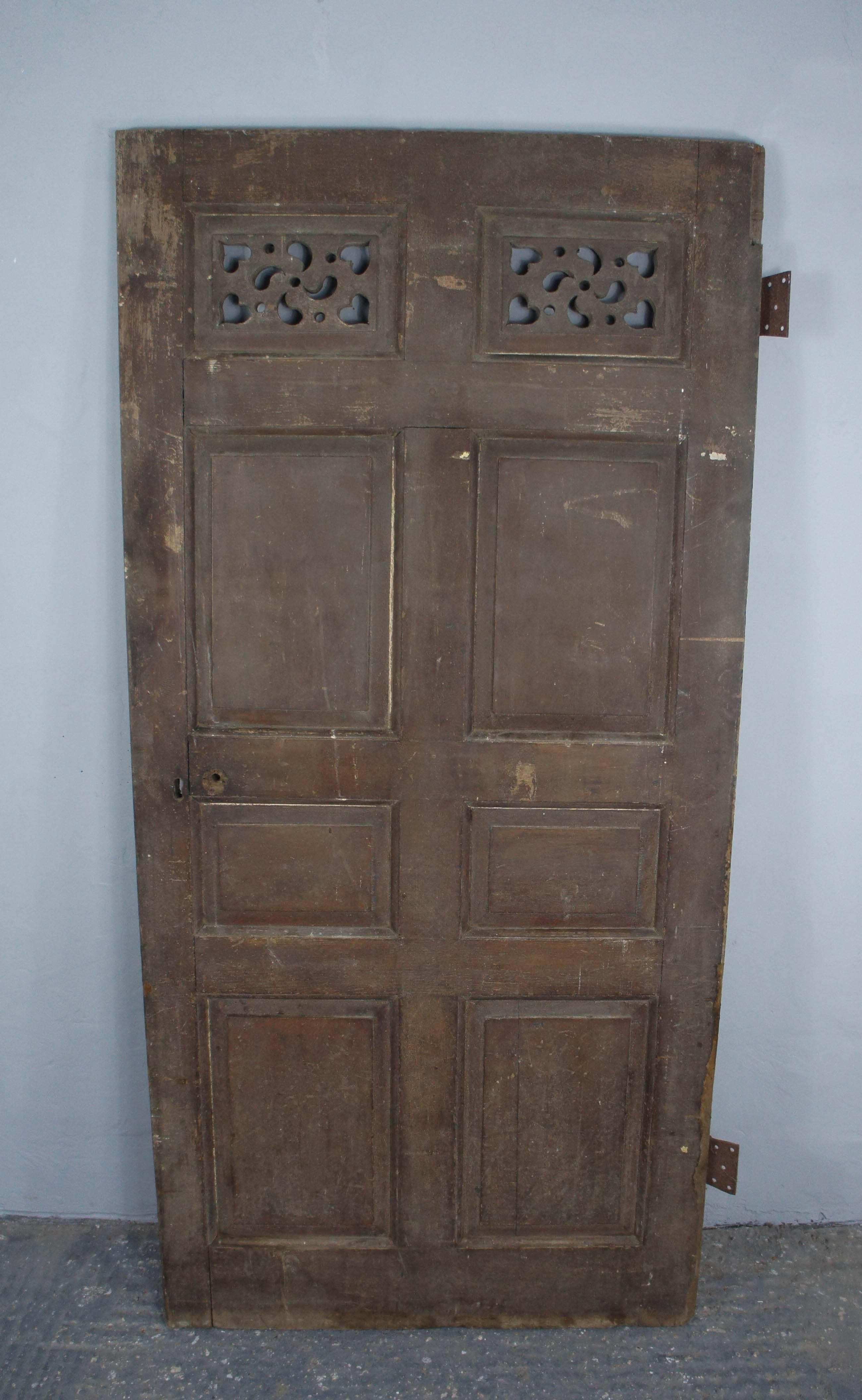 English oak door from a Lincolnshire estate house originating from the early 1800s. It has original paint, hinges and handcarved feature panel.
Great decorative item or practical to be reused in a period home. 