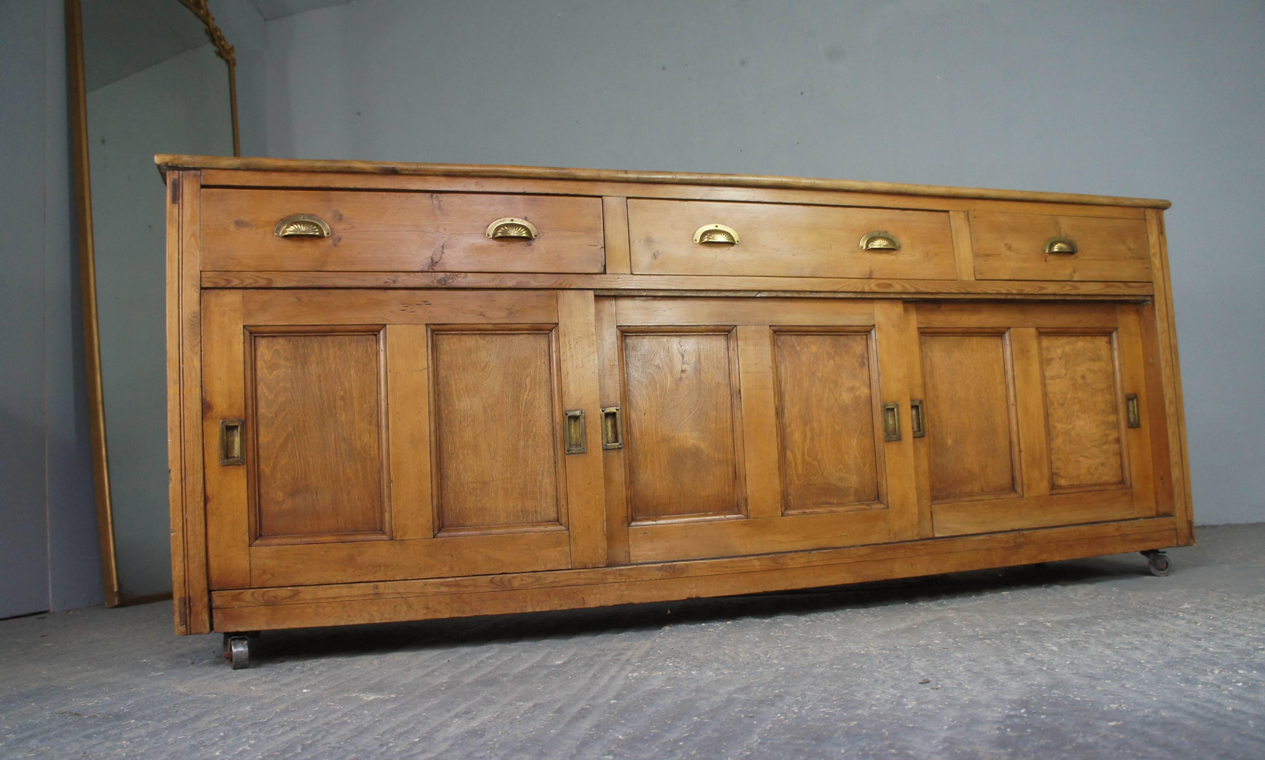 Beautiful Victorian pine dresser base with hardwood top, featuring two drawers and one false drawer on right hand side. Below the drawers are three sliding doors which reveal plenty of storage options; shelves to the middle and left hand side and an