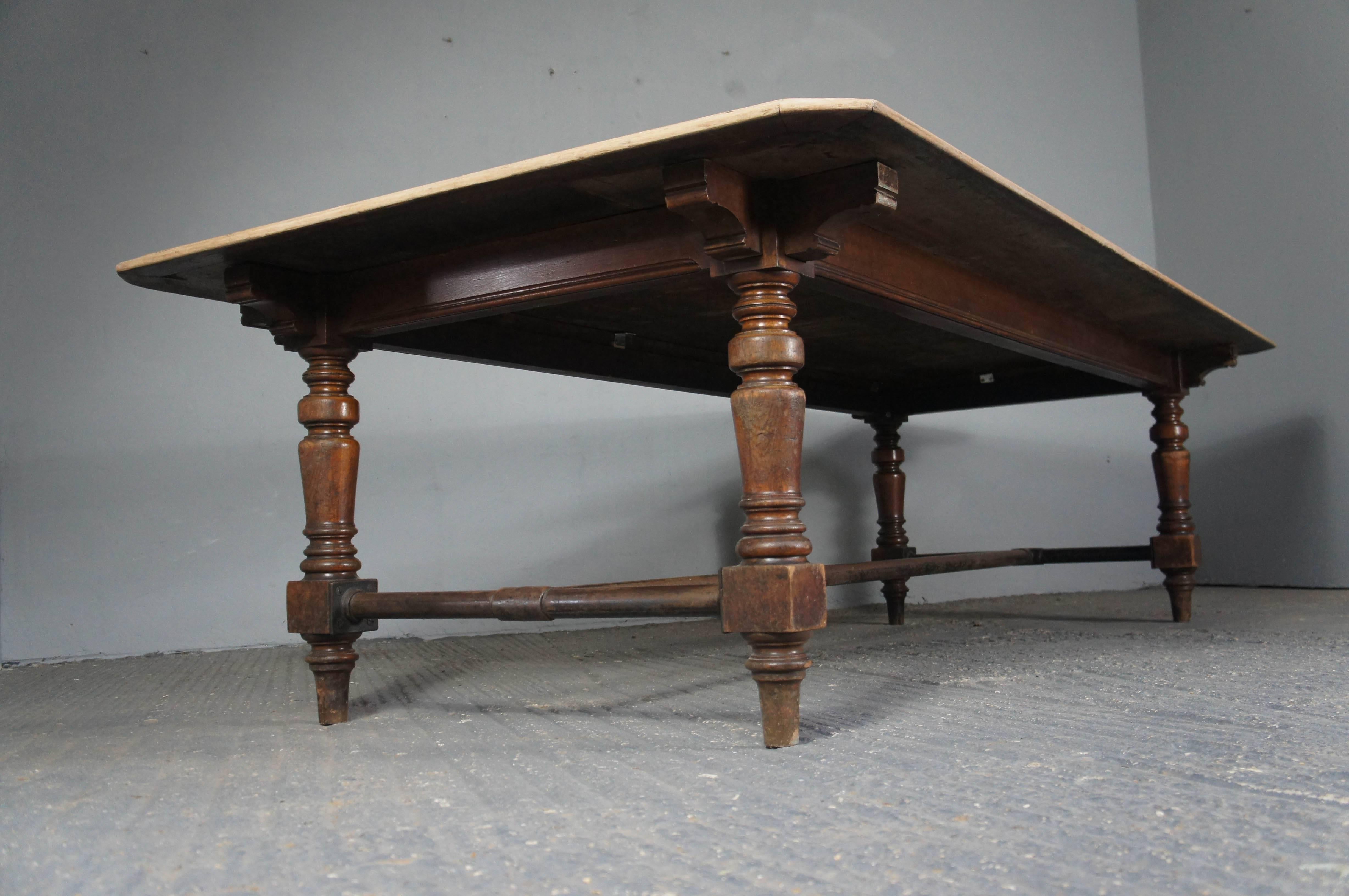 Huge mahogany dining table with bleached top. It features four turned legs and a later, rather unusual but quirky addition of a metal runner, as shown in the pictures. Comfortably seats 10-12 people. It matches perfectly with the pair of oak jointed