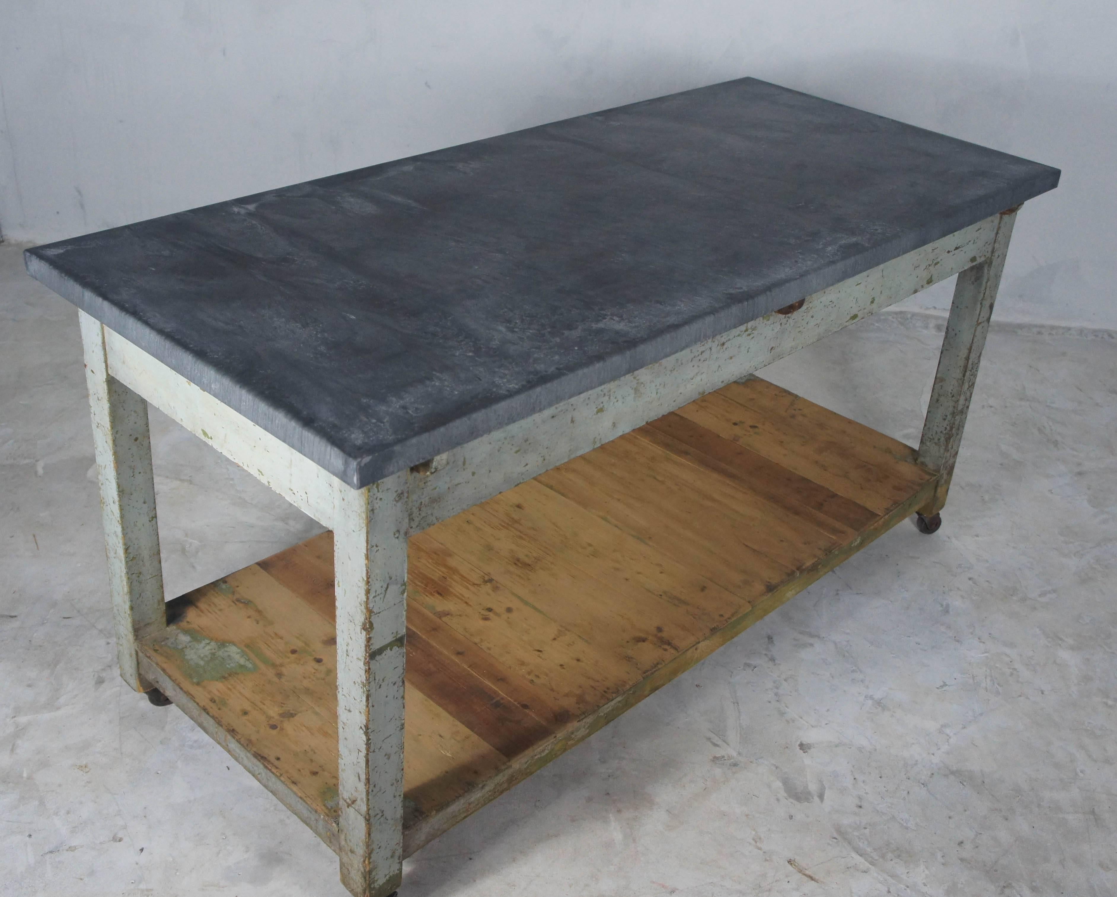 Great looking pine farmhouse table, sourced in France and finished with an aged zinc top. The grey-blue paint has worn over the years to a very nice patina, one that is virtually impossible to replicate. There are a few old woodworm holes which have