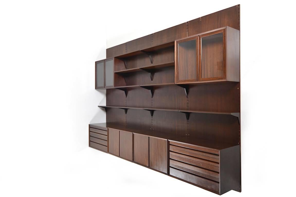 Royal wall or shelf system in walnut. Designed by Poul Cadovius. Manufactured by Cado.
11 shelves / Six bookcase or cabinets / Four panels / 
measurements:
shelf: 6x 30.0 x 80.0 CM (D x W) / 5x 22.0 x 80.0 CM (D x W) / cabinets: 2x 30.0 x 80.0 x