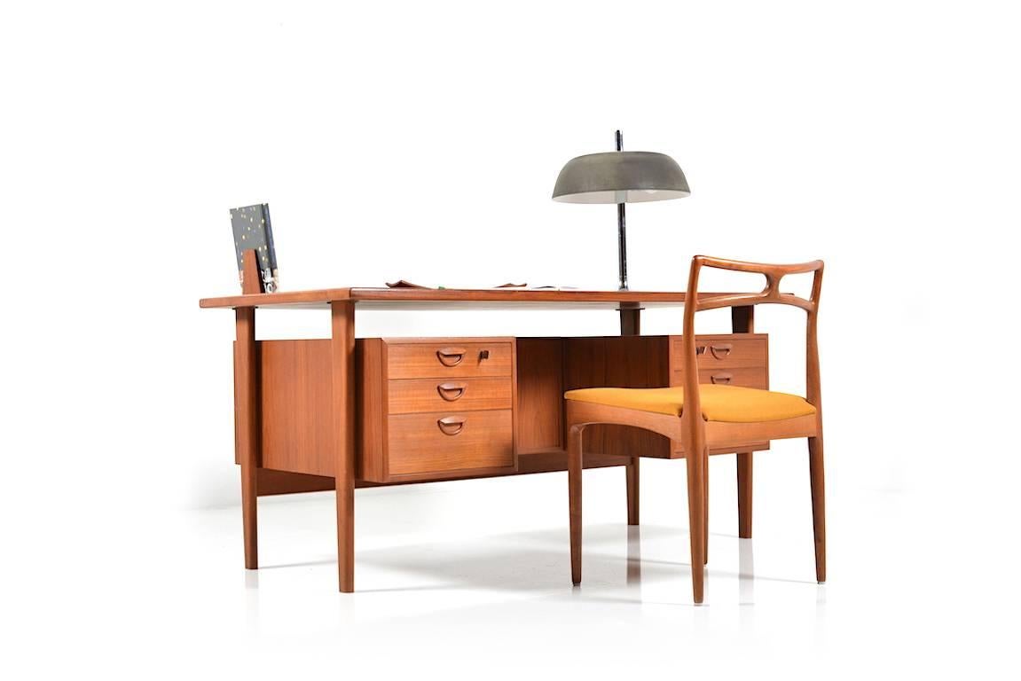 Mid-Century Danish freestanding teak desk. Designed by Kai Kristiansen. Manufactured by FM. Model FM60. With three drawers on each side and forward with open shelves. Original Stand in nice vintage condition.