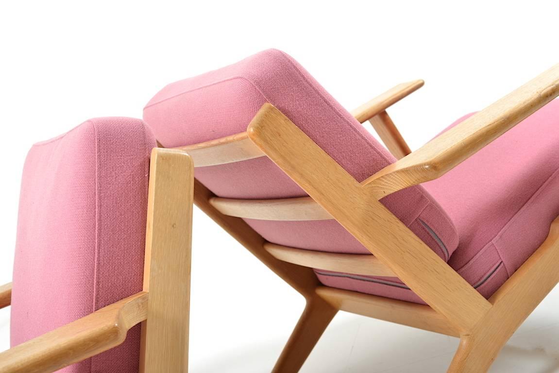Pair of easychairs in solid oak. Model GE-290 by Hans J. Wegner. Manufactured by GETAMA. Original cushions in rose wool fabric.

Note: Please see the matching sofa.