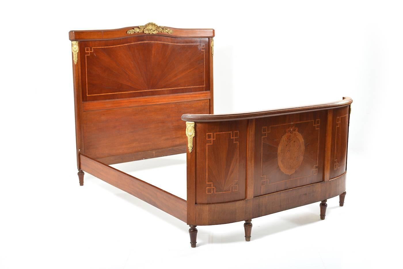 Beautiful French double-bed, 19th century, circa 1860. Mahogany massive and veneer. Marquetry in birch wood and walnut. Original fire-gilded bronze fittings.
In good antique stand, with use of trace and old patina.
  