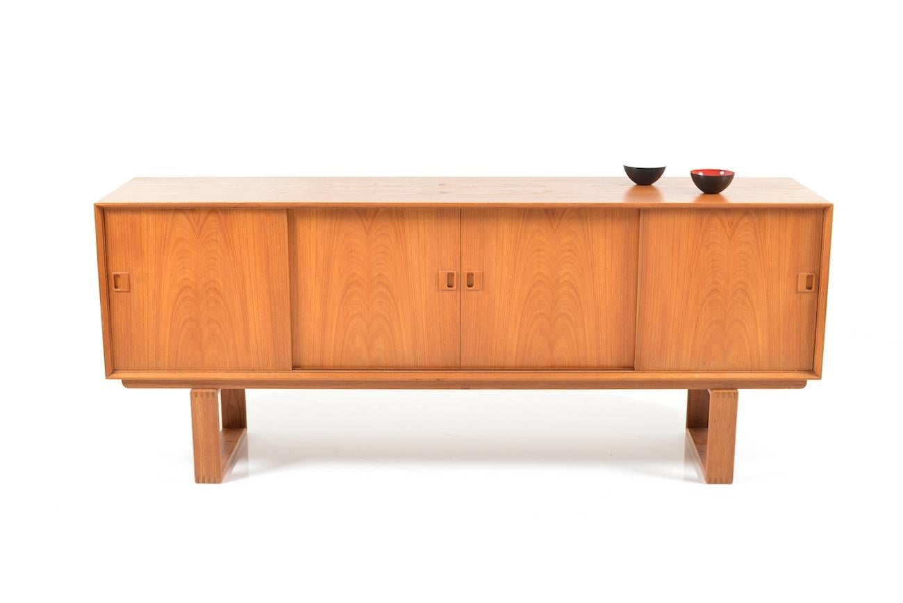 Danish sideboard in teak. Four sliding doors, behind with drawers. Made in Denmark, circa 1968. Very good vintage condition.