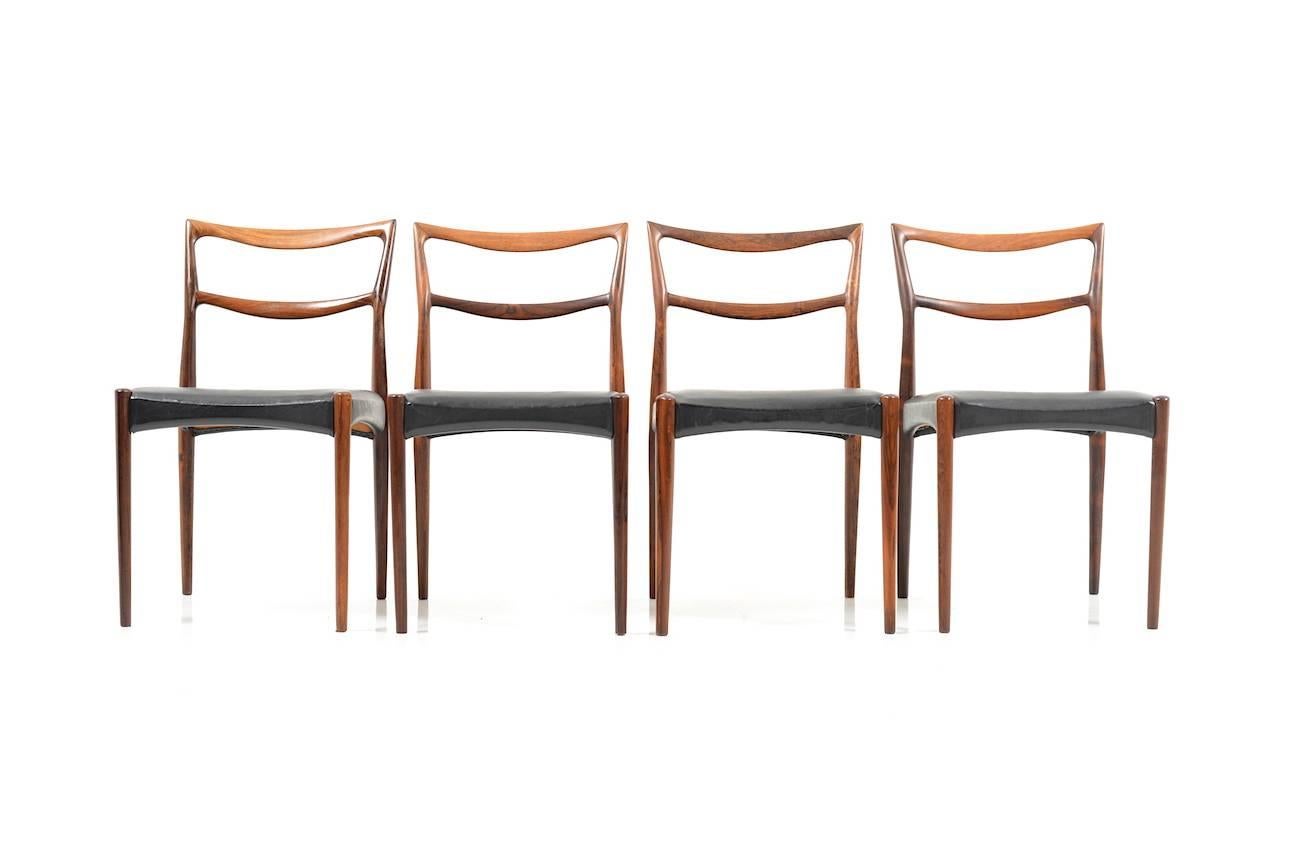 Set of four (4) Danish rosewood dining chairs. Manufactured in 1960s. Seats in original black leather. Fine Danish quality!