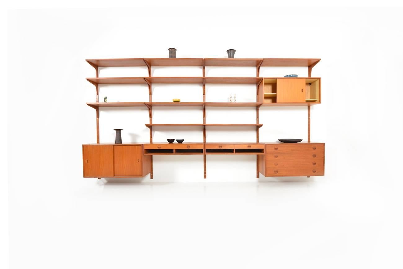 Exclusive and rare teak wall unit by Rud Thygesen & Johnny Sørensen. Manufactured by HG Furniture.
The wall unit consists of: 12 shelfs, five cabinets, seven wall brackets.
 