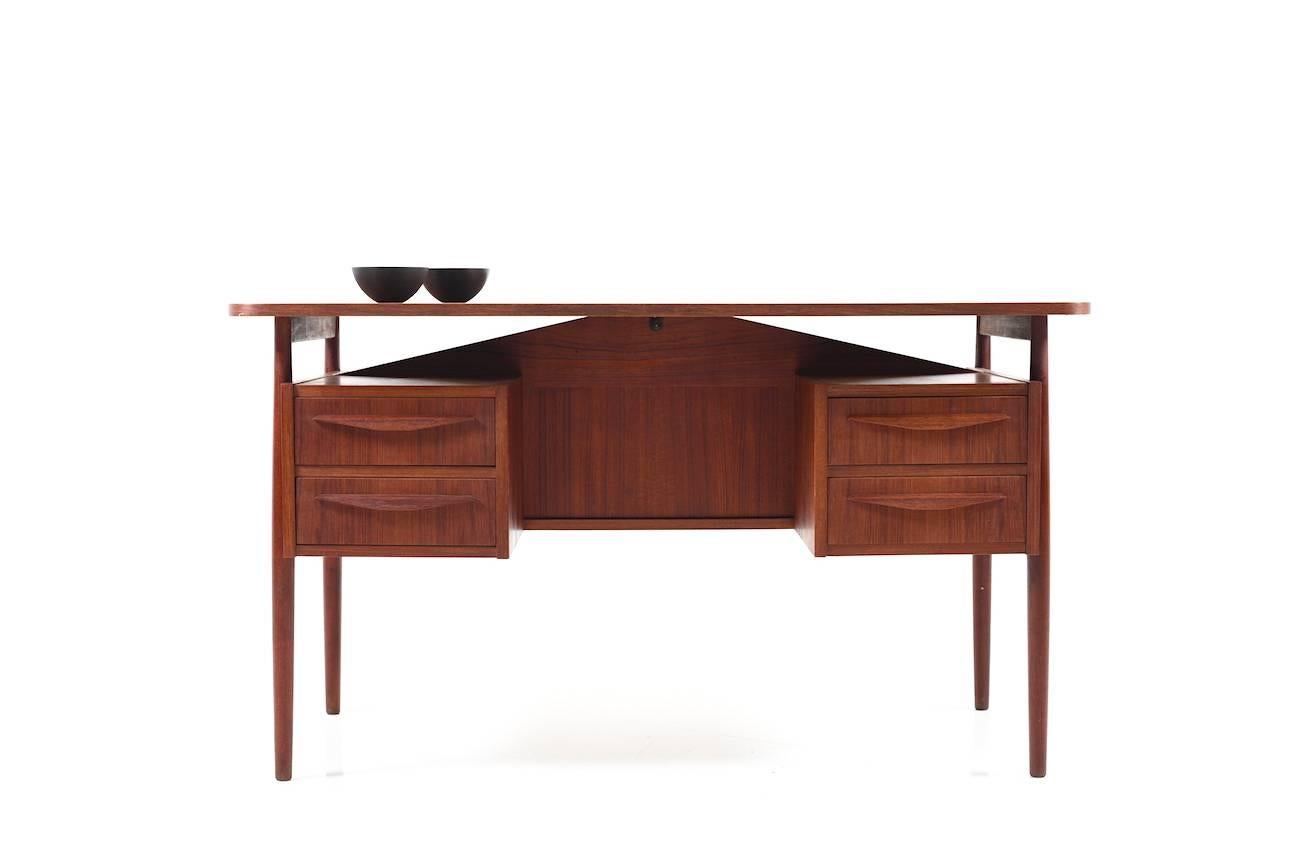 Early Danish freestanding desk in teak. Each site with two drawers, 1950s. In beautiful dark teak. fine Danish quality.