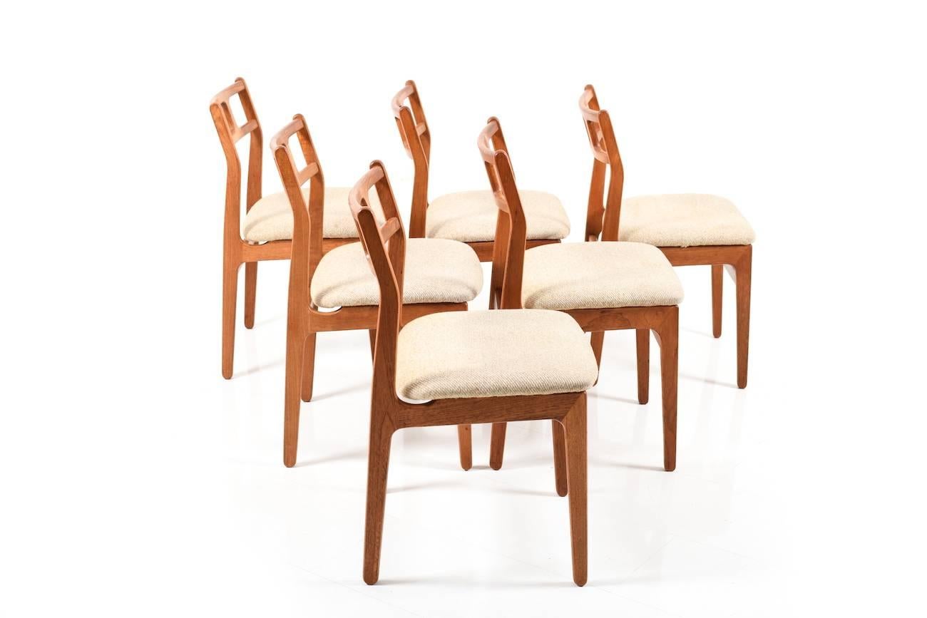 Set of six Danish dining chairs in teak. Seats in beige/brown wool fabric.