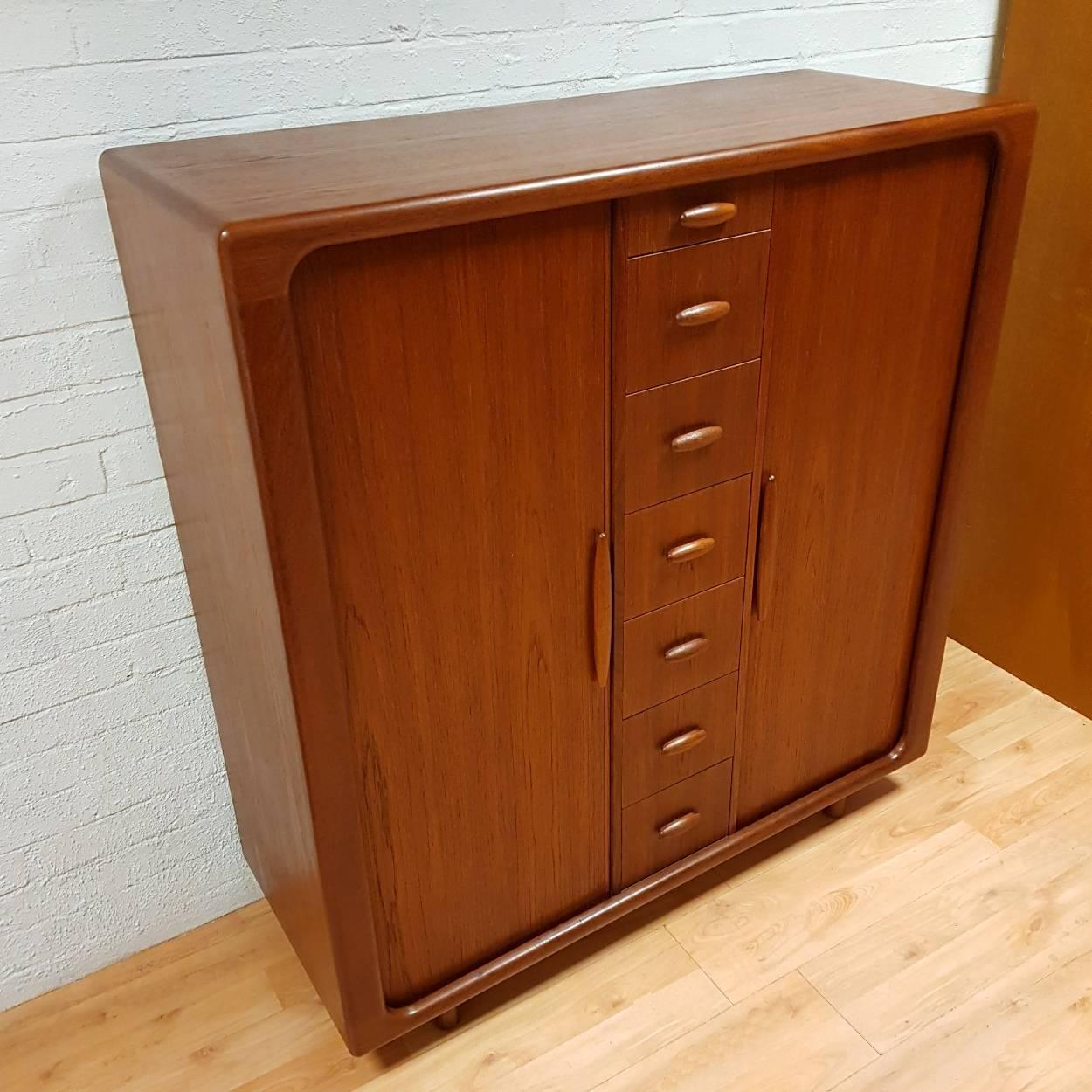 Beautiful Mid-Century Modern teak gentlemen’s chest / dresser by Dyrlund of Denmark. Beautifully proportioned and high quality piece of furniture with very stylish lines, whilst having a small footprint. The cabinet consists of two tambour cupboard