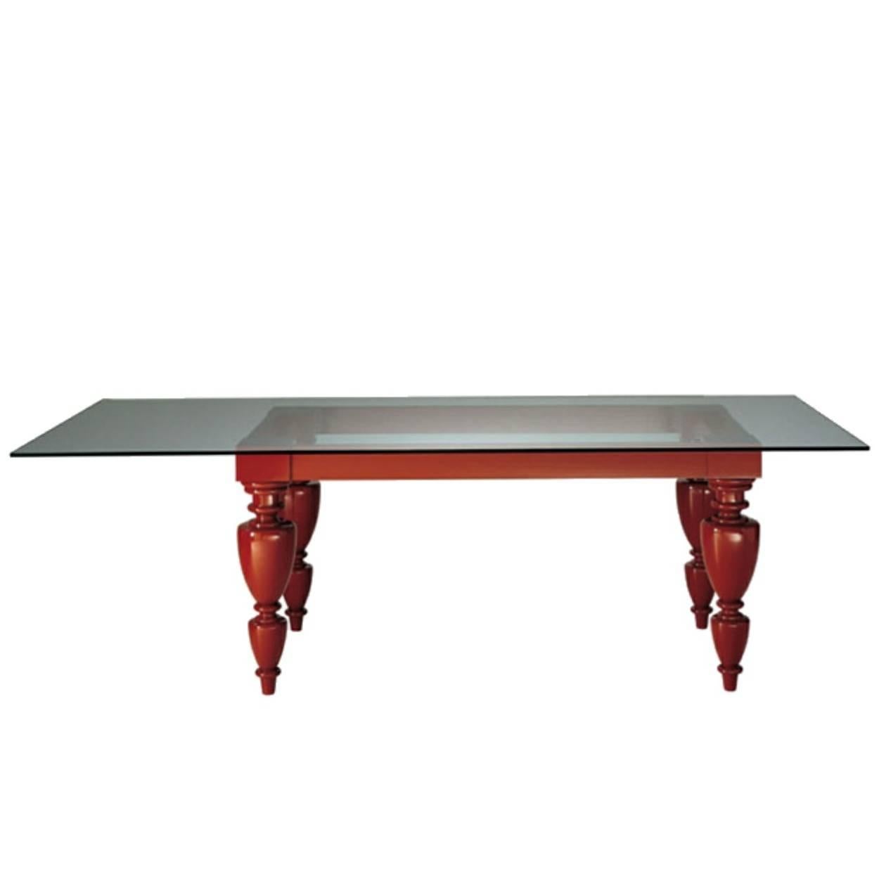 Original Zanotta Dorian 7025 dining table. Designed by Dominique Matthieu for Zanotta in 2002. Glossy lacquered wooden table legs and frame in red (RAL3003) with a 12mm thick plate glass top. Contemporary Italian design at its' finest.