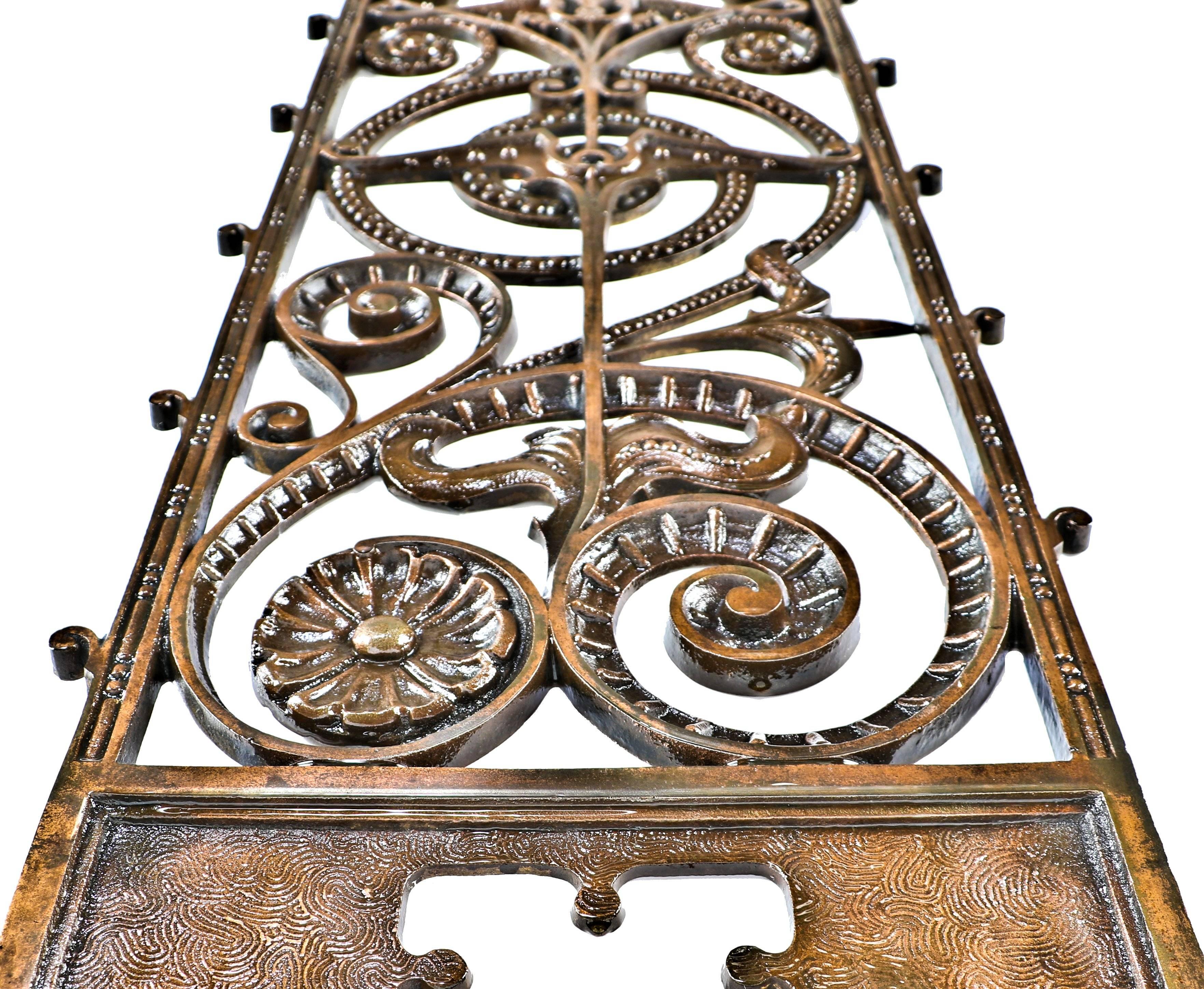 All original and exceptionally intact historically important 19th century American copper-plated cast iron interior elevator lobby grille panel salvaged from the extant Downtown Chicago Manhattan building. The single-sided heavily ornamented iron
