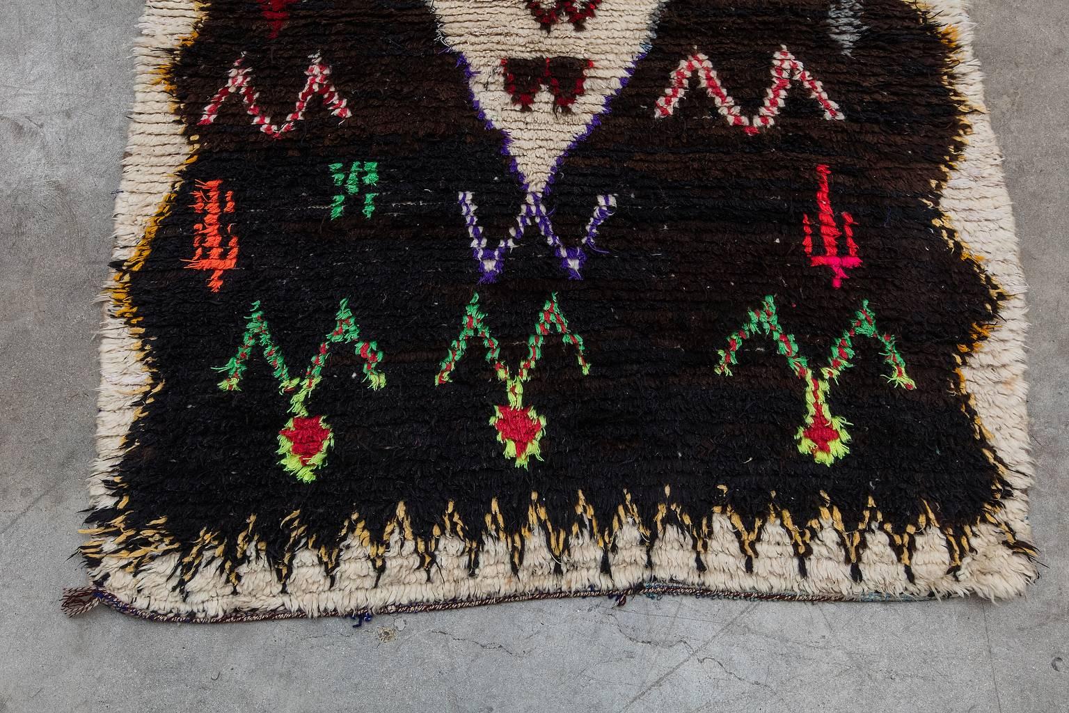 This stunning artistic piece is made by the Azilal Tribe in the High Atlas Mountains of Morocco. This pile rug is mixed with warm shaggy wool and cotton fibers. 

Measurement does not include fringe.