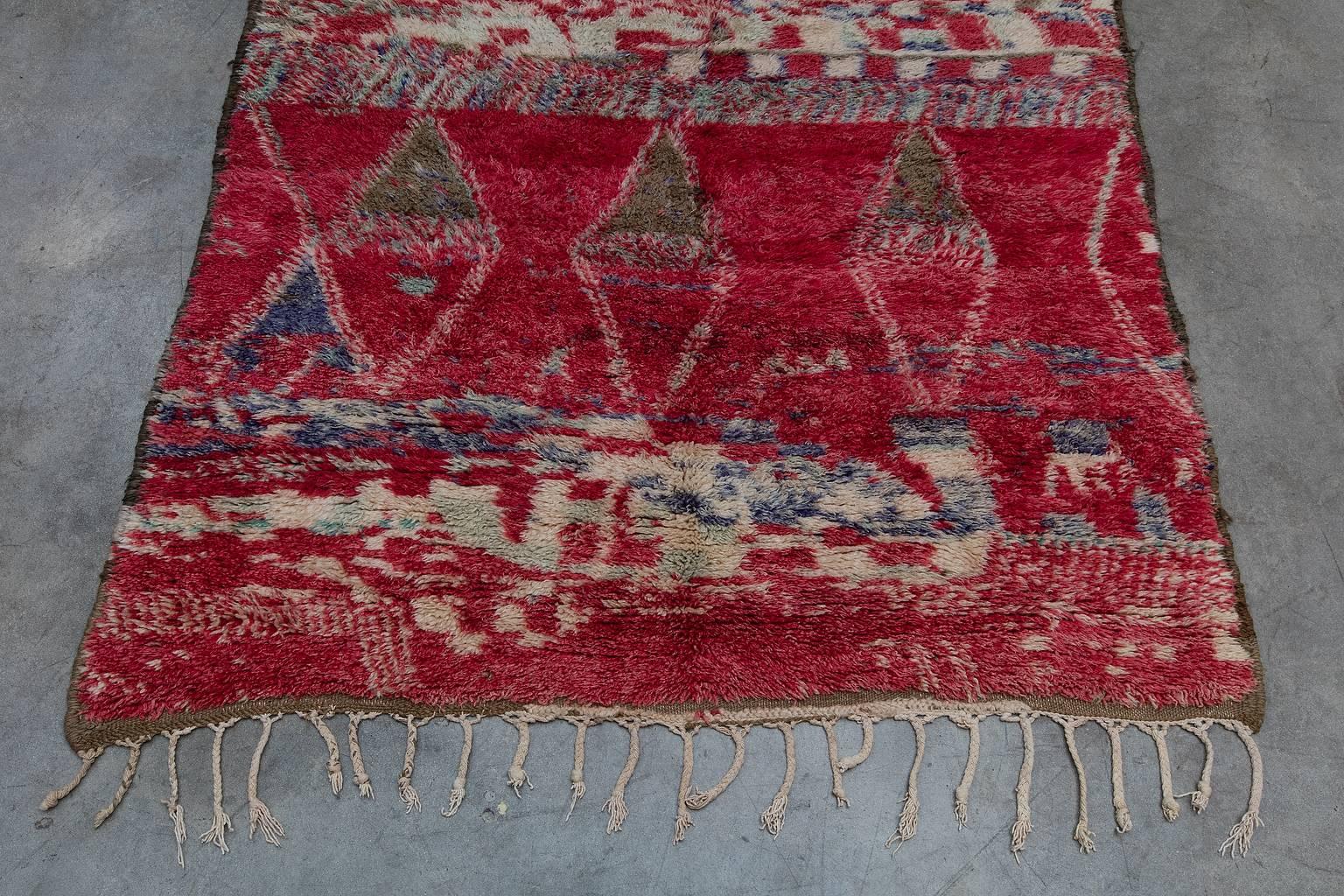 The Beni M'Guild tribe yields from the middle atlas region of Morocco. Their rugs tend to be very plush, woven to provide warmth and comfort during the winter months. Beni M'Guild rugs feature a well-known composition of diamonds in the