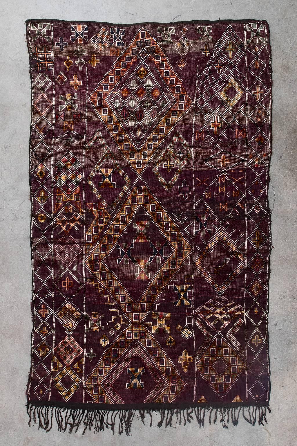 The Beni M'Guild Tribe yields from the middle Atlas region of Morocco. Their rugs tend to be very plush, woven to provide warmth and comfort during the winter months. Beni M'Guild Rugs feature a well-known composition of diamonds in the