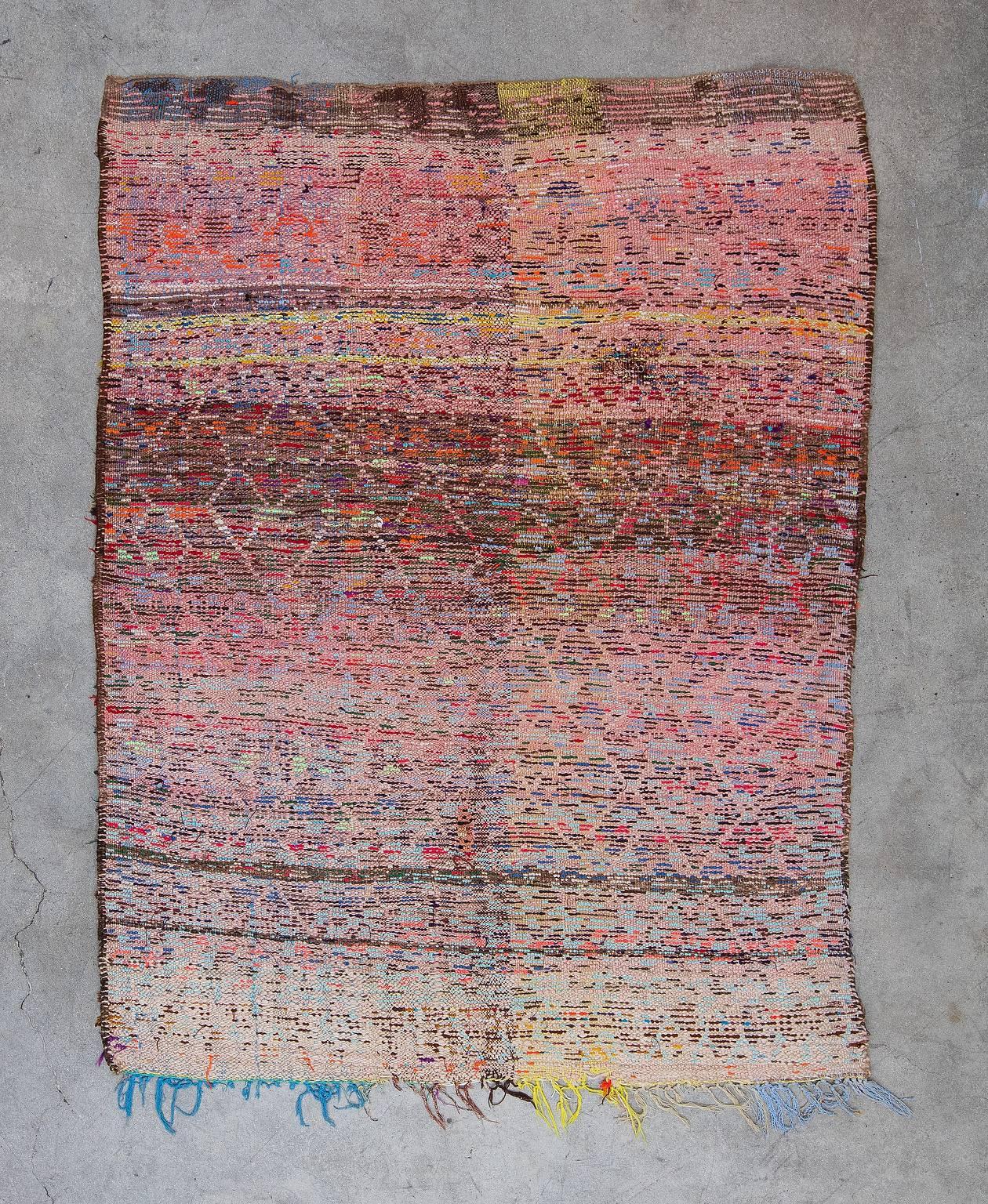 Moroccan Boucherouite rugs are woven by Berber tribal women for domestic use in the home. The word Boucherouite stems from the Arabic bu sherwit meaning “a scrap from used clothing”. Indeed these whimsical works of art are made from recycled cloth