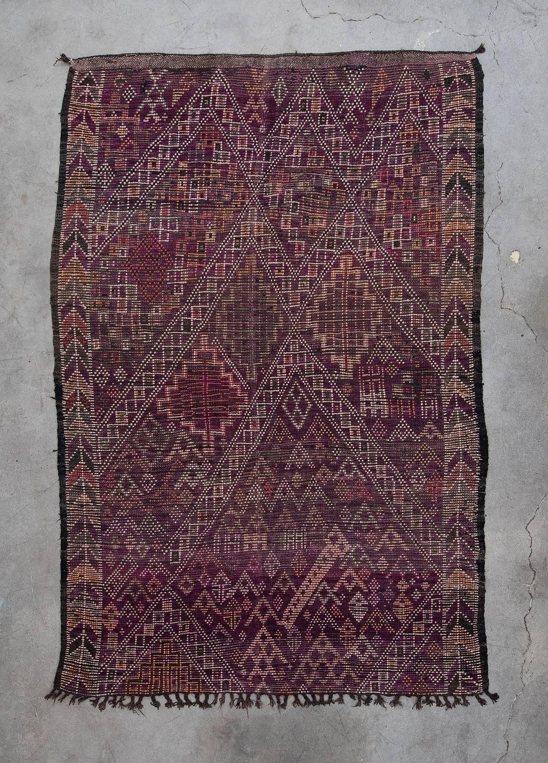 The Beni M'Guild Tribe yields from the middle Atlas region of Morocco. Their rugs tend to be very plush, woven to provide warmth and comfort during the winter months. Beni M'Guild rugs feature a well-known composition of diamonds in the