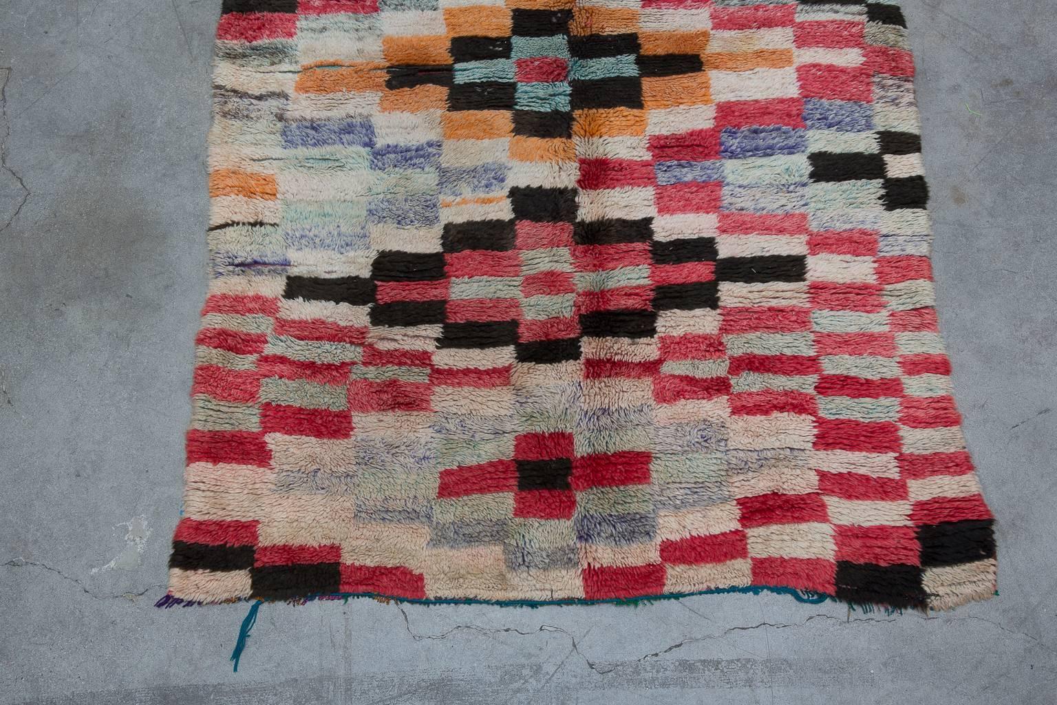 This stunning artistic piece is made by the Azilal tribe in the High Atlas Mountains of Morocco. The rug has very soft wool with a medium pile.

The multicolored checker pattern gives this piece a warm whimsical feel.

 