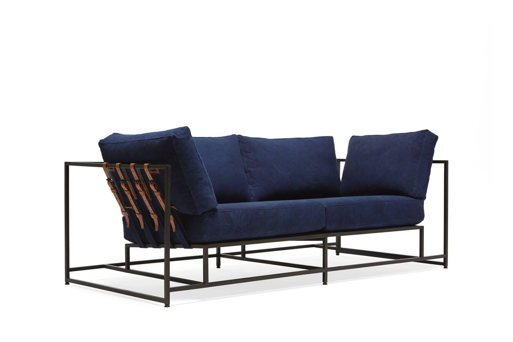 The Inheritance Two Seat Sofa by Stephen Kenn is as comfortable as it is unique. The design features an exposed construction composed of three elements - a steel frame, plush upholstery, and supportive belts. The deep seating area is perfect for a