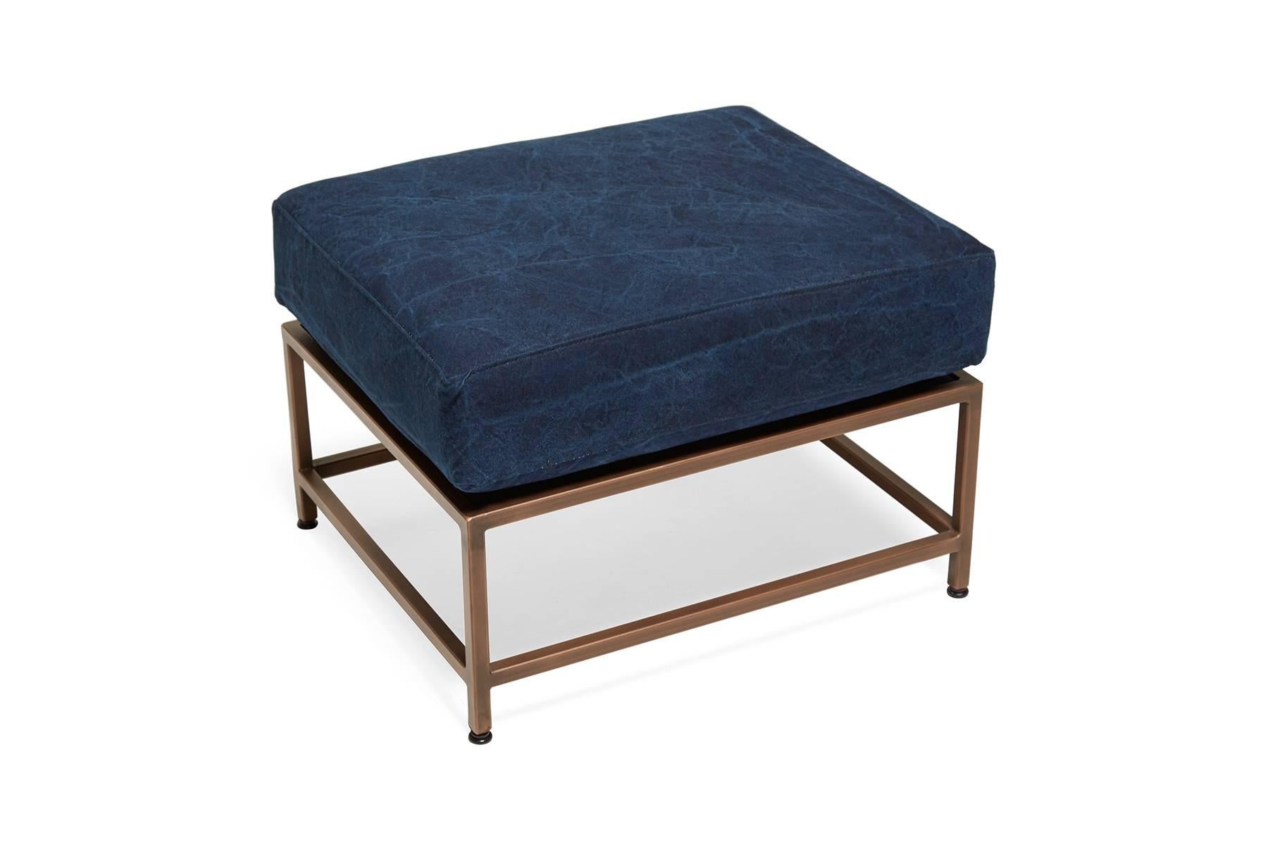 Inspired by a worn-in pair of jeans and created alongside the team at Simon Miller USA, this Ottoman has naturally dyed indigo cotton canvas upholstery atop an antique copper frame. Each piece of canvas is hand-dyed and has unique texture and color
