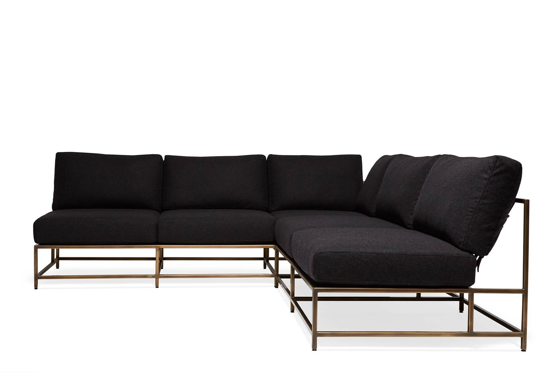 A larger sectional style piece with open sides, an antique brass frame finish and charcoal wool blend upholstery. This item can function as three independent pieces, lined up to create an extra long sofa, or be placed together as a larger L-shaped