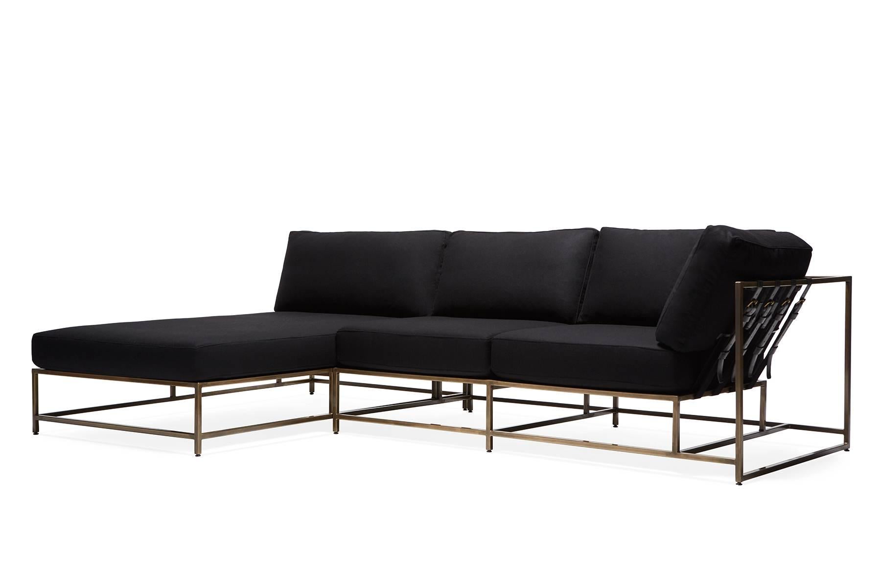 A small sectional style piece with an antique brass frame finish and charcoal wool blend upholstery. This item can function as two independent pieces, or be placed together as a larger sectional style sofa and chaise longue.

Dimensions: 111 W x 38