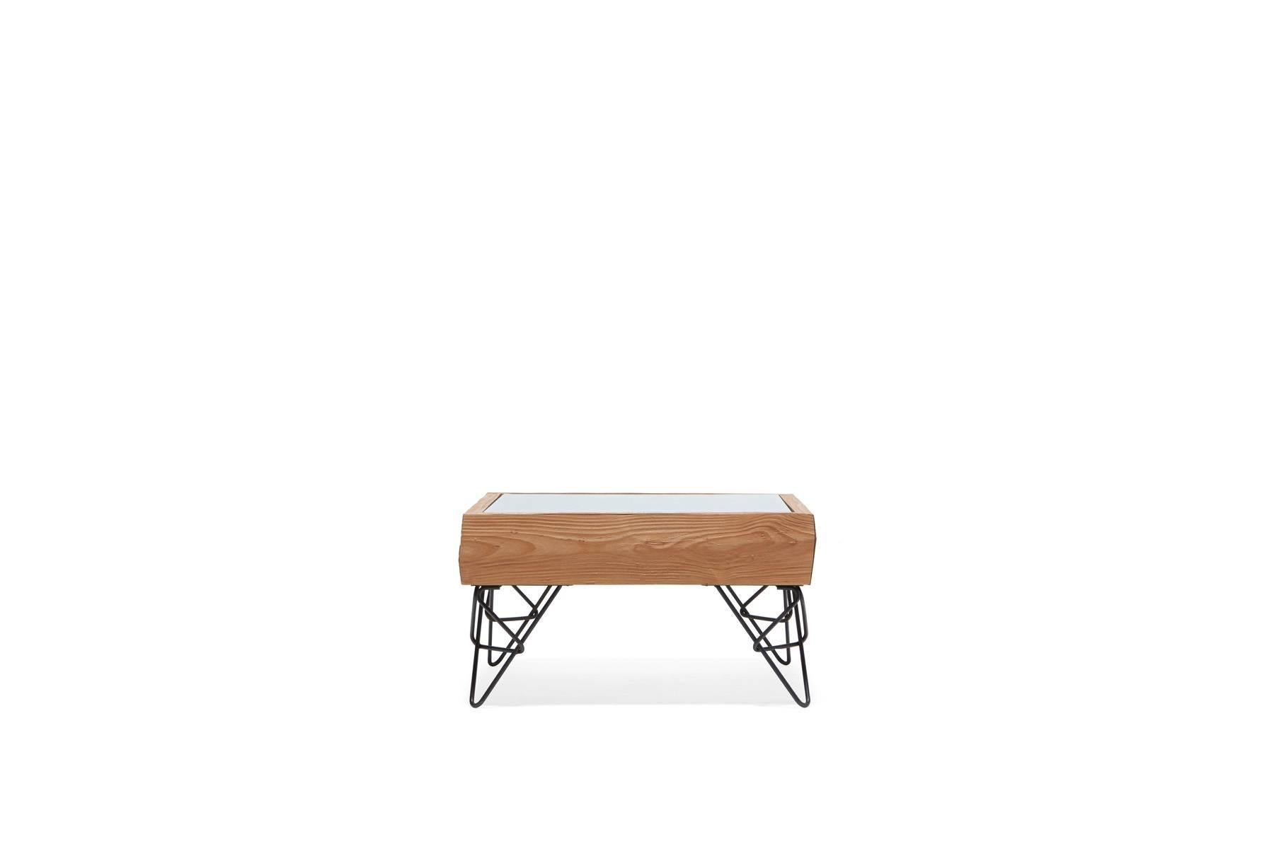 Sandblasted alder wood to simulate the effect that water and sand have on driftwood, paired with black hairpin legs in a unique design. The table has a hidden drawer to allow out-of-sight storage as well as access to the wood tray beneath the glass