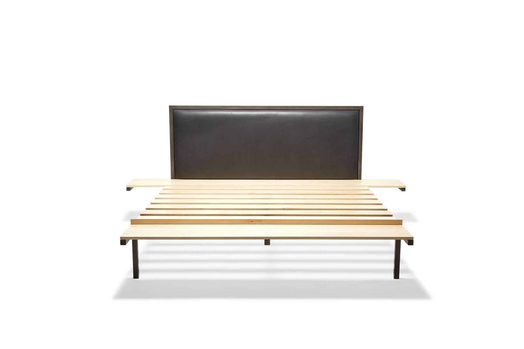 New for Stephen Kenn in 2016 is the Inheritance bed. The frame is tube steel in blackened steel, with a smoky blue leather headboard and Maple side table, bench and slats. The side tables and bench are integrated into the frame of the bed, creating