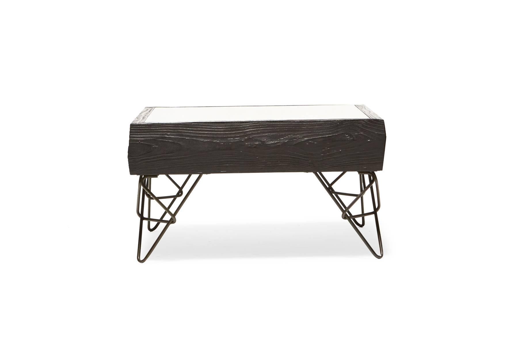 Sandblasted then ebonized alder wood to simulate the effect that water and sand have on driftwood, paired with black hairpin legs in a unique design. The table has a hidden drawer to allow out-of-sight storage as well as access to the wood tray
