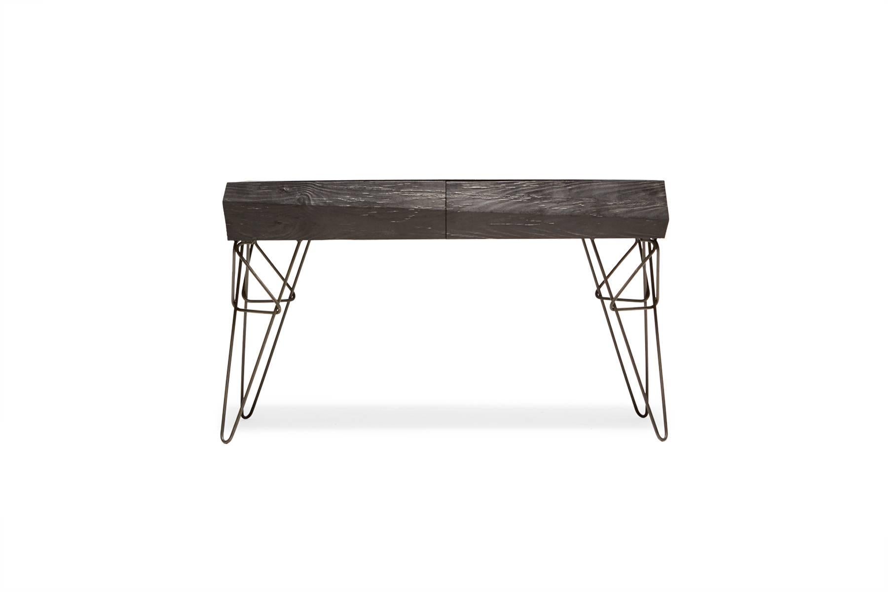 Sandblasted then ebonized alder wood to simulate the effect that water and sand have on driftwood, paired with black hairpin legs in a unique design. The table has two hidden drawers to allow for out-of-sight storage.