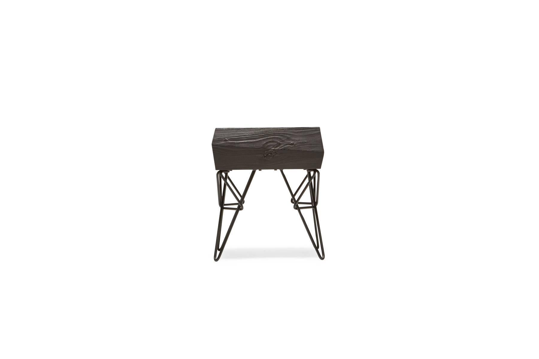 Sandblasted then ebonized alder wood to simulate the effect that water and sand have on driftwood, paired with matte black steel legs. The table has a hidden drawer to allow for out-of-sight storage.