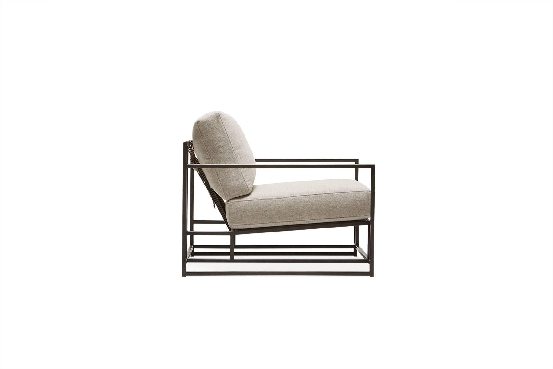 The Inheritance Armchair by Stephen Kenn is as comfortable as it is unique. The design features an exposed construction composed of three elements - a steel frame, plush upholstery, and supportive belts. The deep seating area is perfect for a