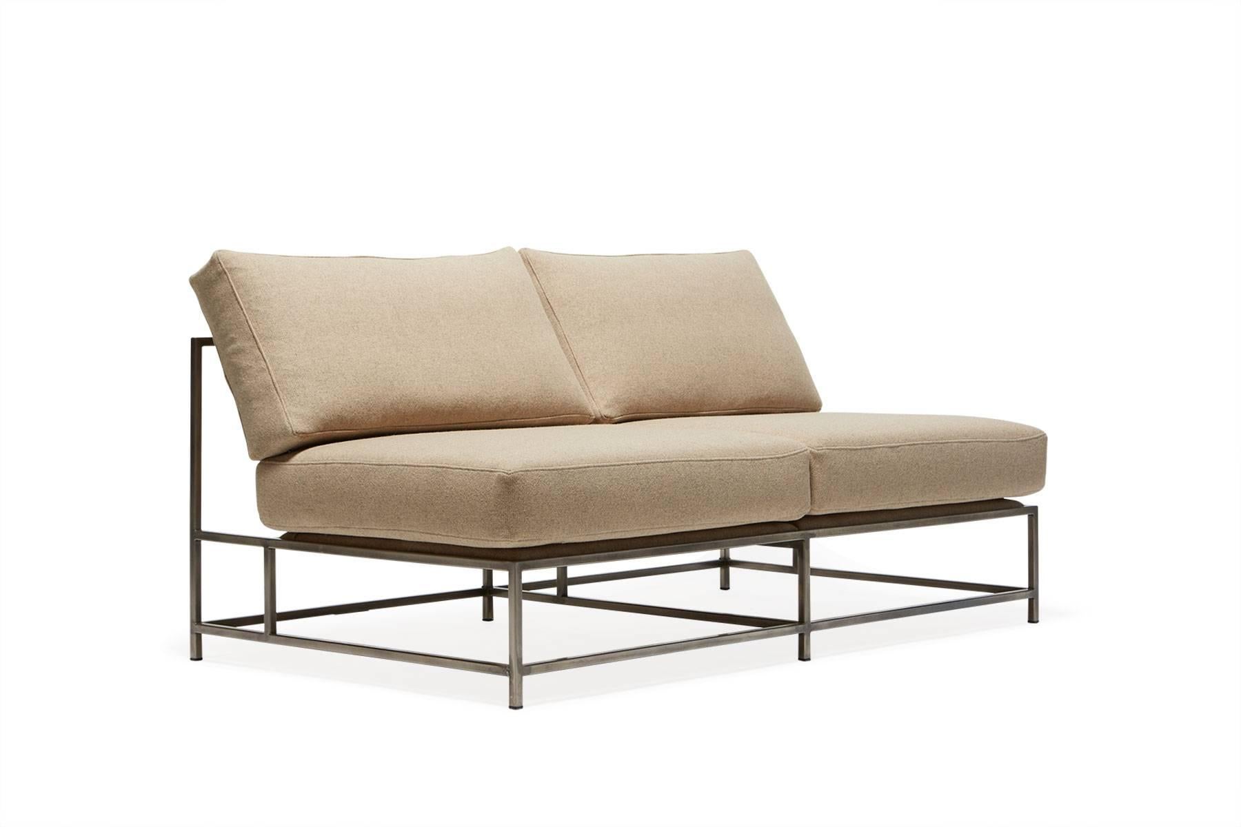 The Inheritance Loveseat by Stephen Kenn is as comfortable as it is unique. The design features an exposed construction composed of three elements - a steel frame, plush upholstery, and supportive belts. The deep seating area is perfect for a