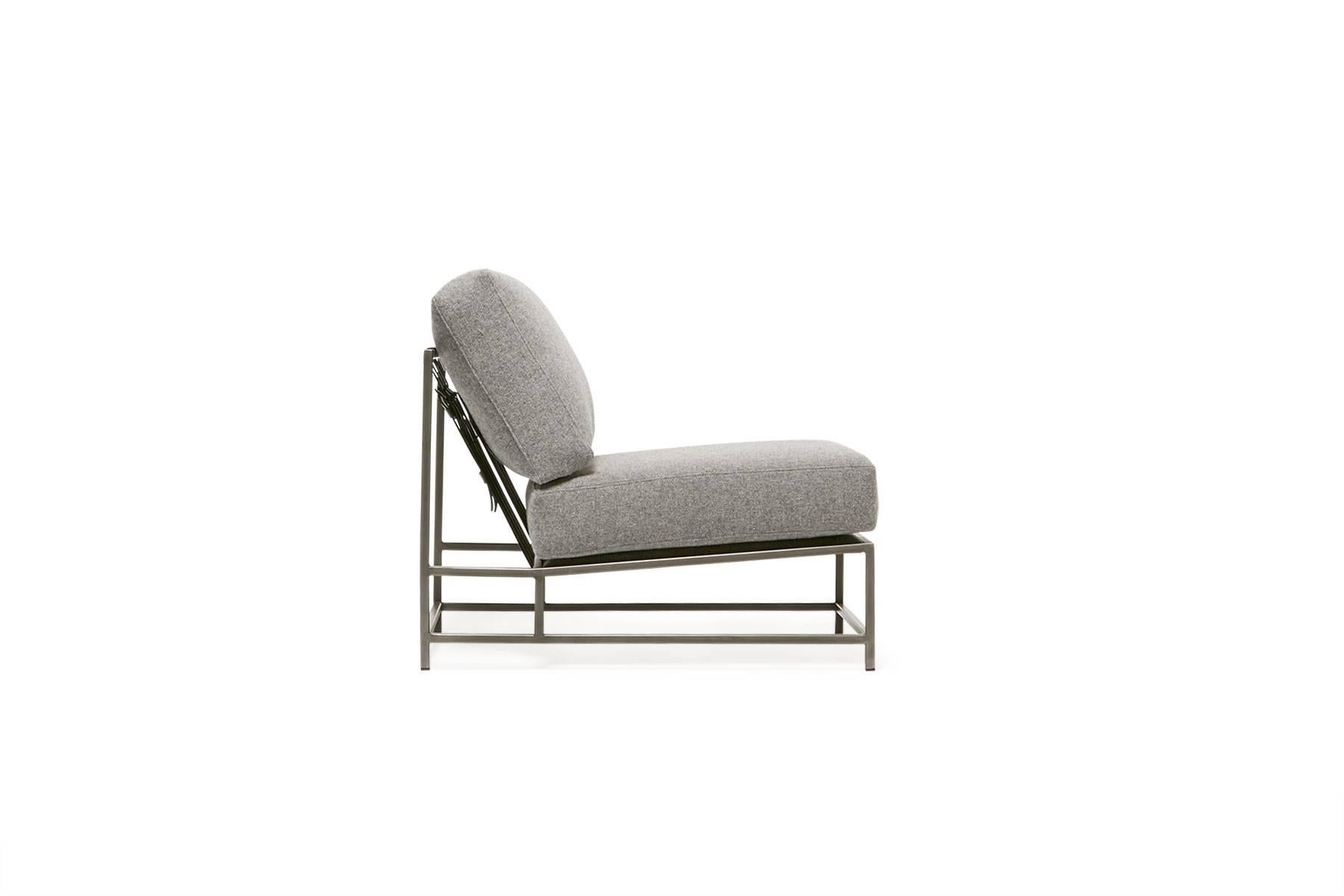 Sleek and refined, the Inheritance Chair is a great addition to nearly any space.  

This variation is upholstered in a plush grey wool. The foam seat cushions have been wrapped in polyfiber, allowing for a soft and comfortable lounge experience.