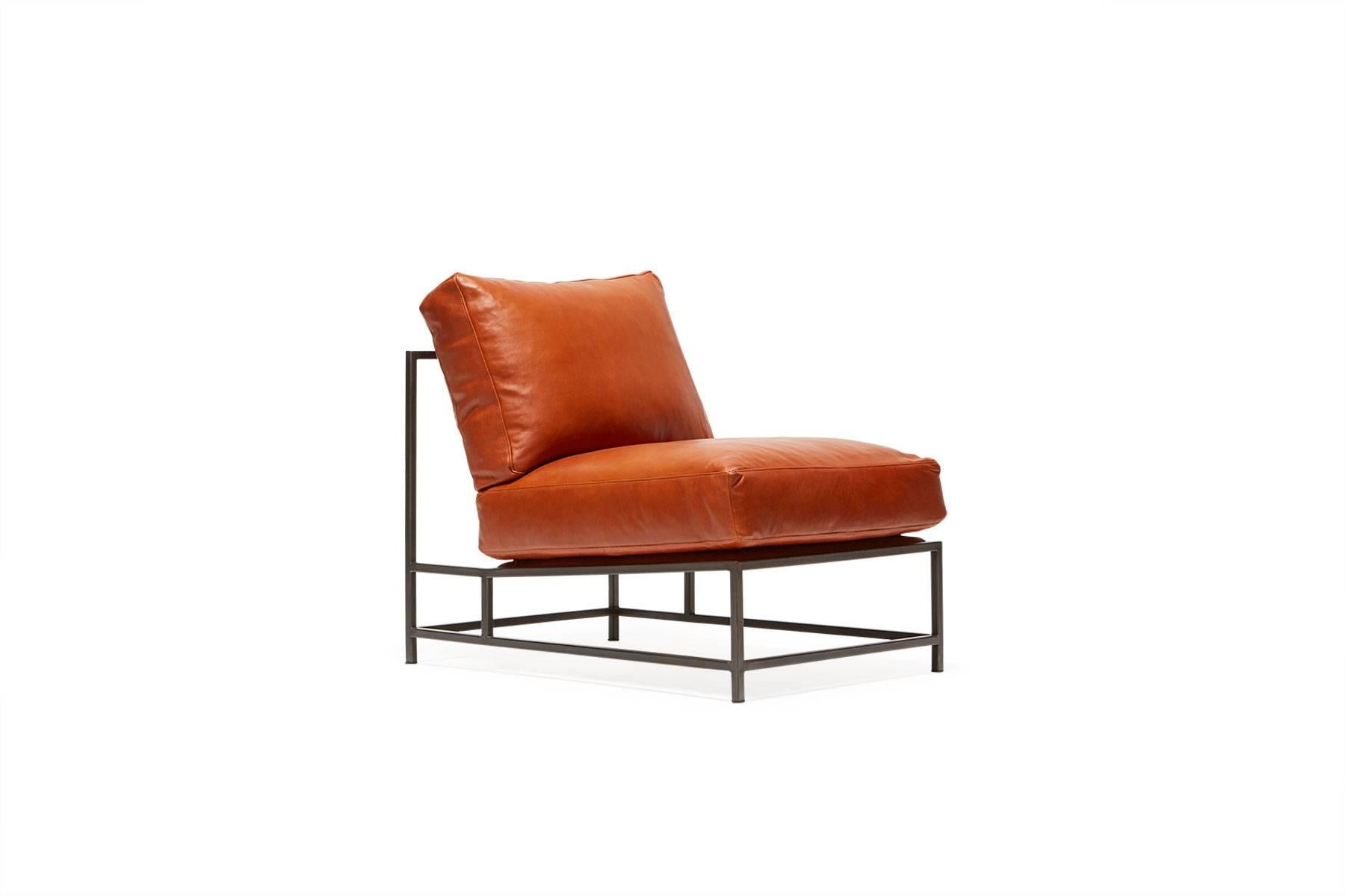 Sleek and refined, the Inheritance Chair is a great addition to nearly any space.  

This variation is upholstered in the same soft, cognac leather as our Encounter Collection bags. The foam seat cushions have been wrapped in down, allowing for a