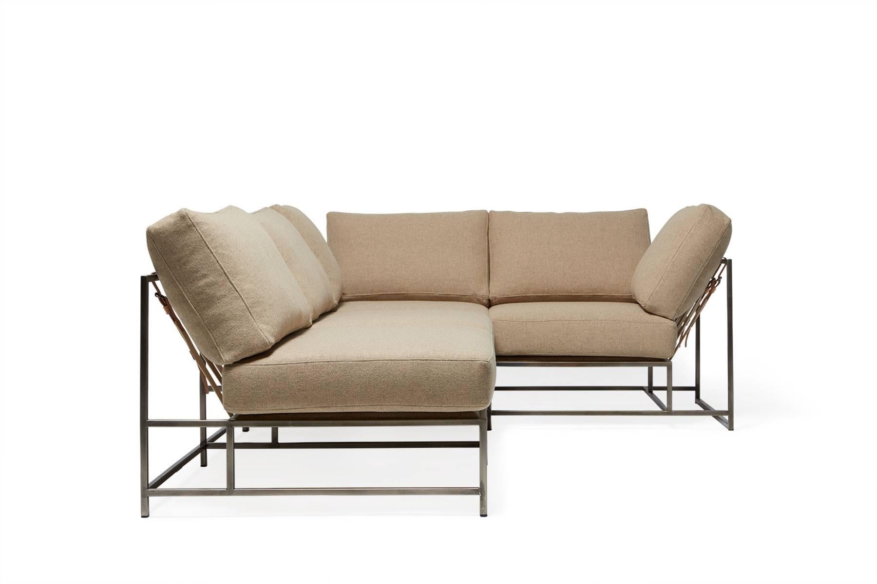 Our sectionals are great ways to customize your space and create the ultimate lounge spaces. 

This variation is upholstered in  a warm tan wool. The foam seat cushions have been wrapped in polyfiber, allowing for a soft and comfortable lounge