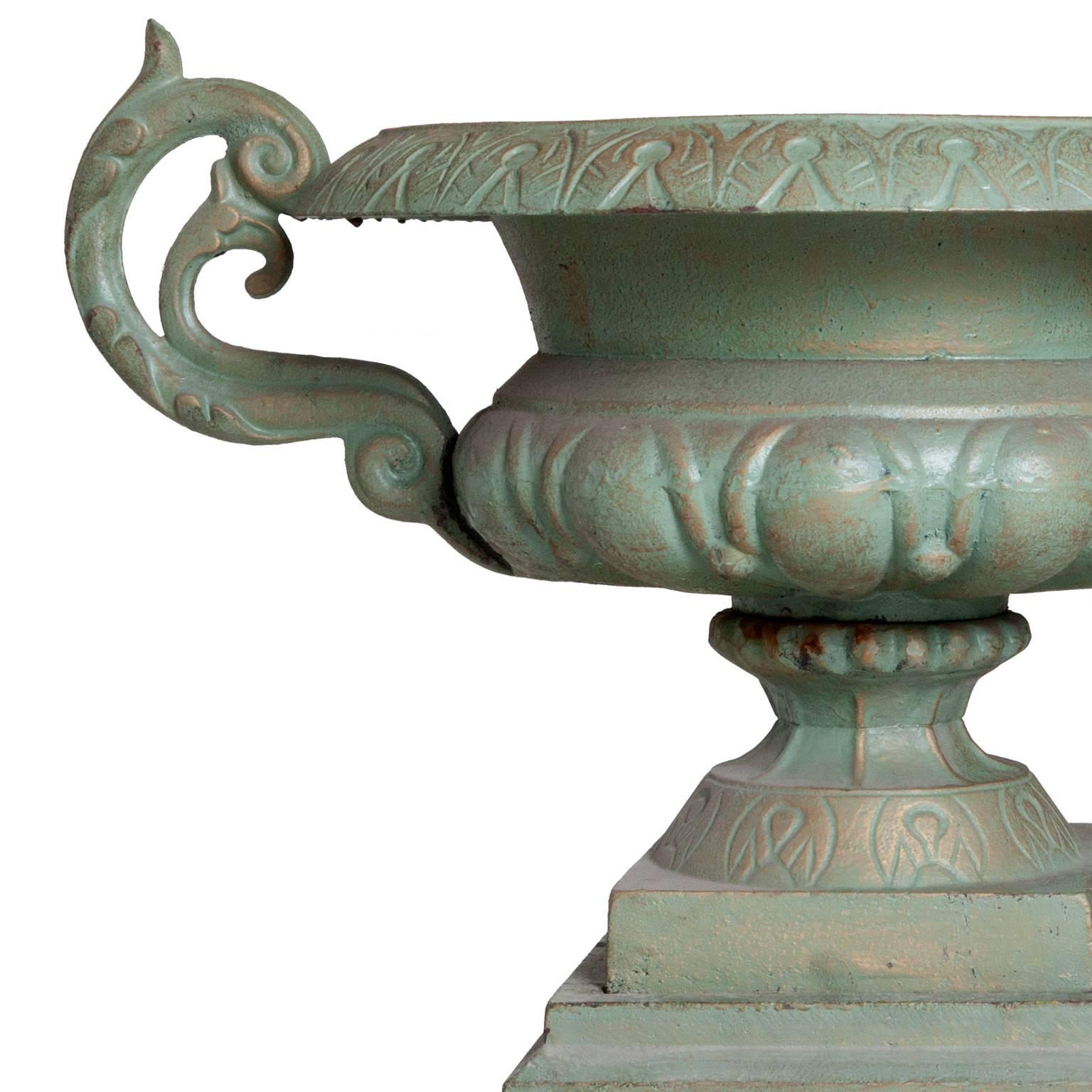 Pair of cast-iron vintage Victorian style urns with unusual patina including matching bases.