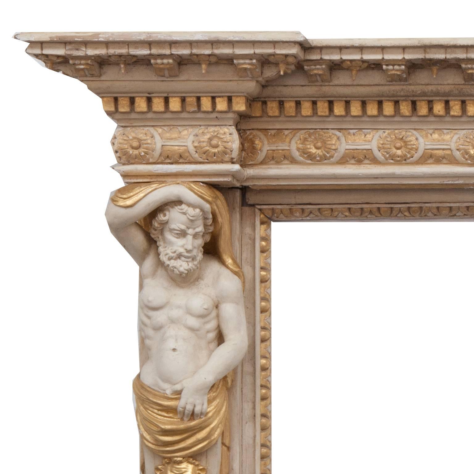 Large 18th century hand-carved Georgian pine fireplace mantel, with bearded caryatid vertical figures and lion mask decoration. Original paint and gilt remain showing a truly fine example of the periods craftsmanship for this most rare fireplace