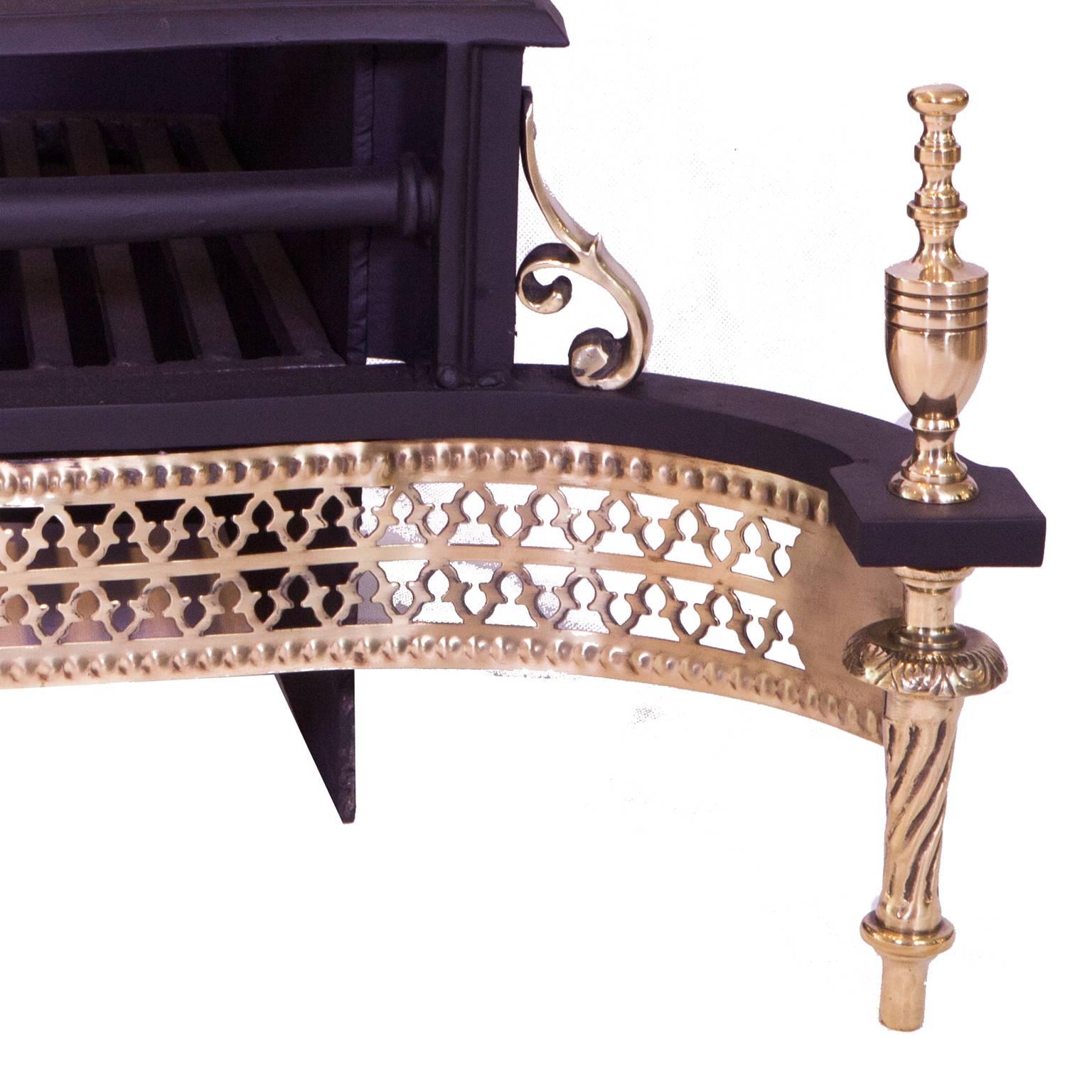 19th century splayed regency cast- iron and brass fretted fire grate inc finial.