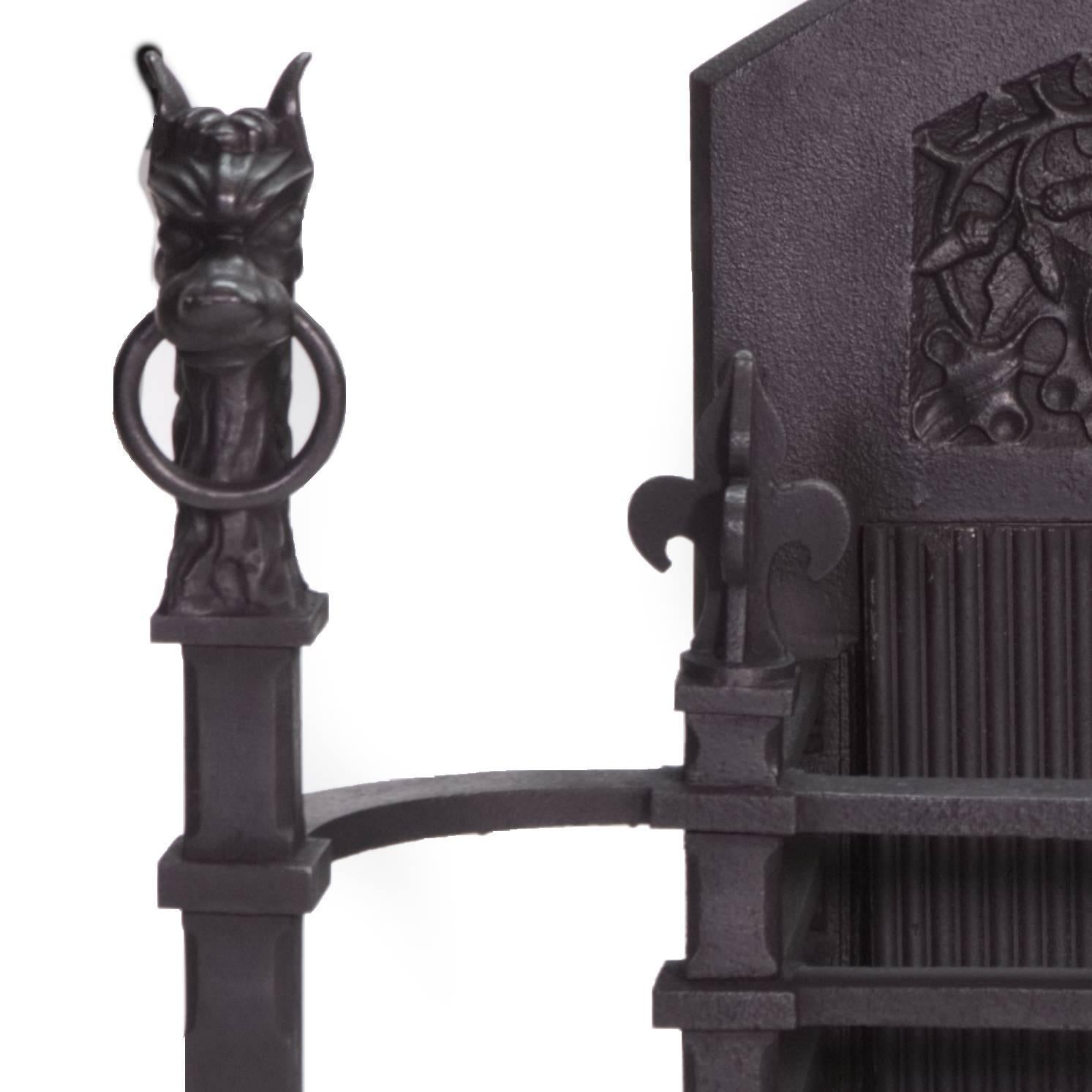 A very powerful antique cast iron Victorian black Gothic fire basket. 
With Very Unique Andirons as stylized griffins with rings through their noses 
and Medieval Styled fire back.

Measures: Back width 22 1/2 (57 cm)
Back height 28 1/4