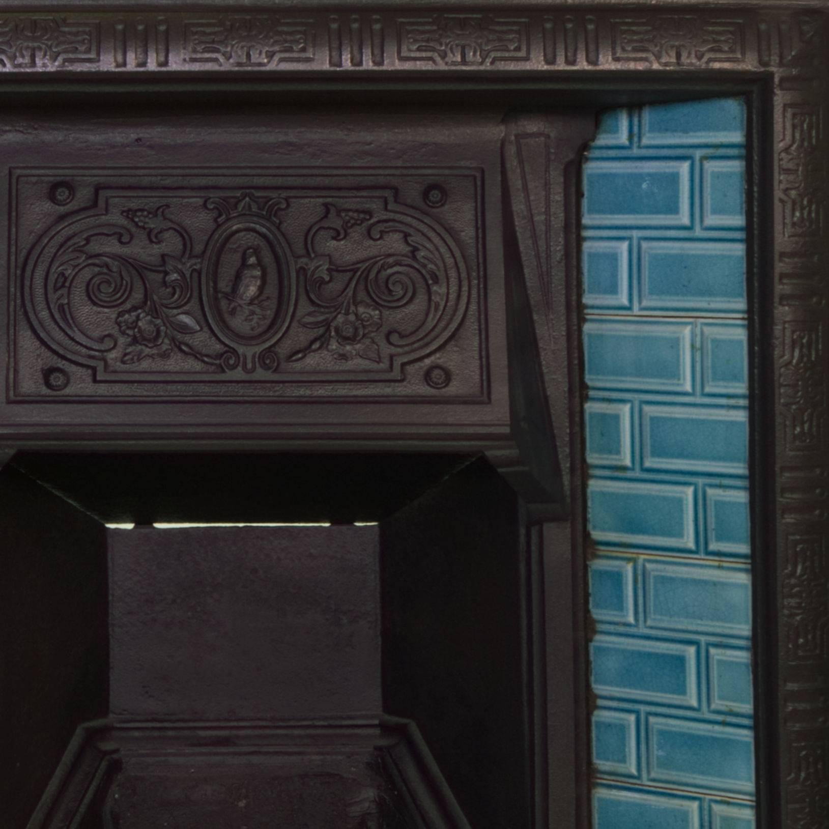 A rare 19th century English Victorian cast-iron tiled fireplace insert.
Blackened iron with original light turquoise tiles.
Beautifully detailed to the canopy and frame boarder.
Salvaged from a London Town house.

Measure: Width 32