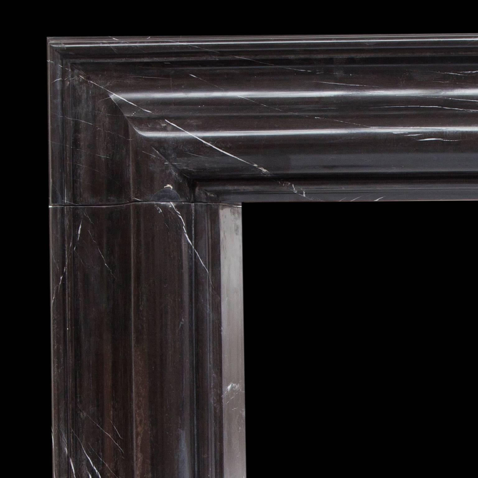 Large bolection fireplace mantel made from beautiful solid Nero Marquina marble.