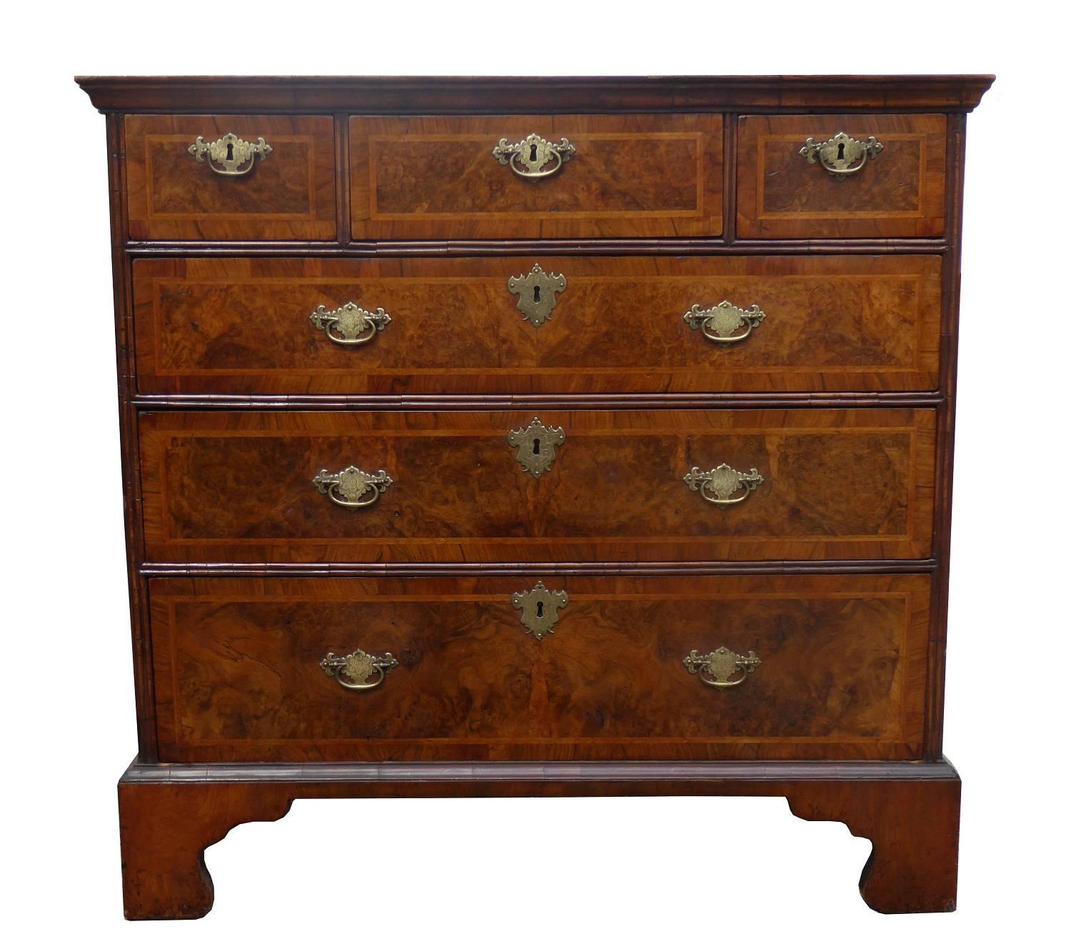 For sale is a good quality Genuine George III burr walnut chest of drawers. The top of the chest has three small drawers above with three further drawers below, each with brass handles. The chest stands on nice bracket feet and is in very good