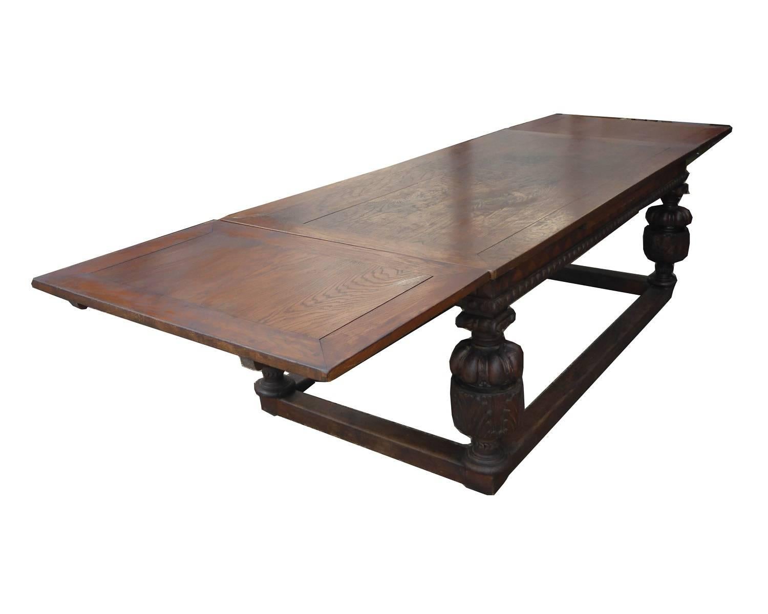 For sale is a very good quality large oak draw leaf refectory table made from solid oak. The table has nice decoration along the border, and stands on four bulbous carved legs, each supported by cross stretchers. The table has two additional leaves
