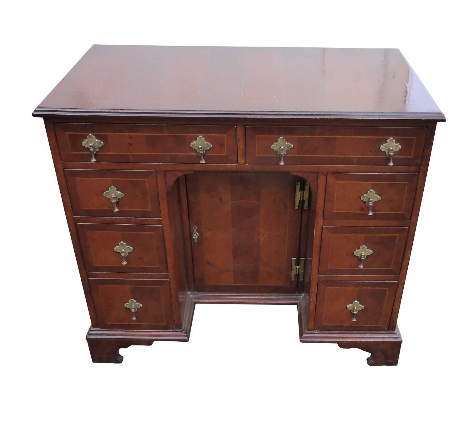 For sale is a good quality Queen Anne style oyster shell and inlaid kneehole desk. The top of the desk has three inlaid circles and is inlaid with oyster shell and crossbanding. Below the top are two drawers, each with stringing inlay and drop